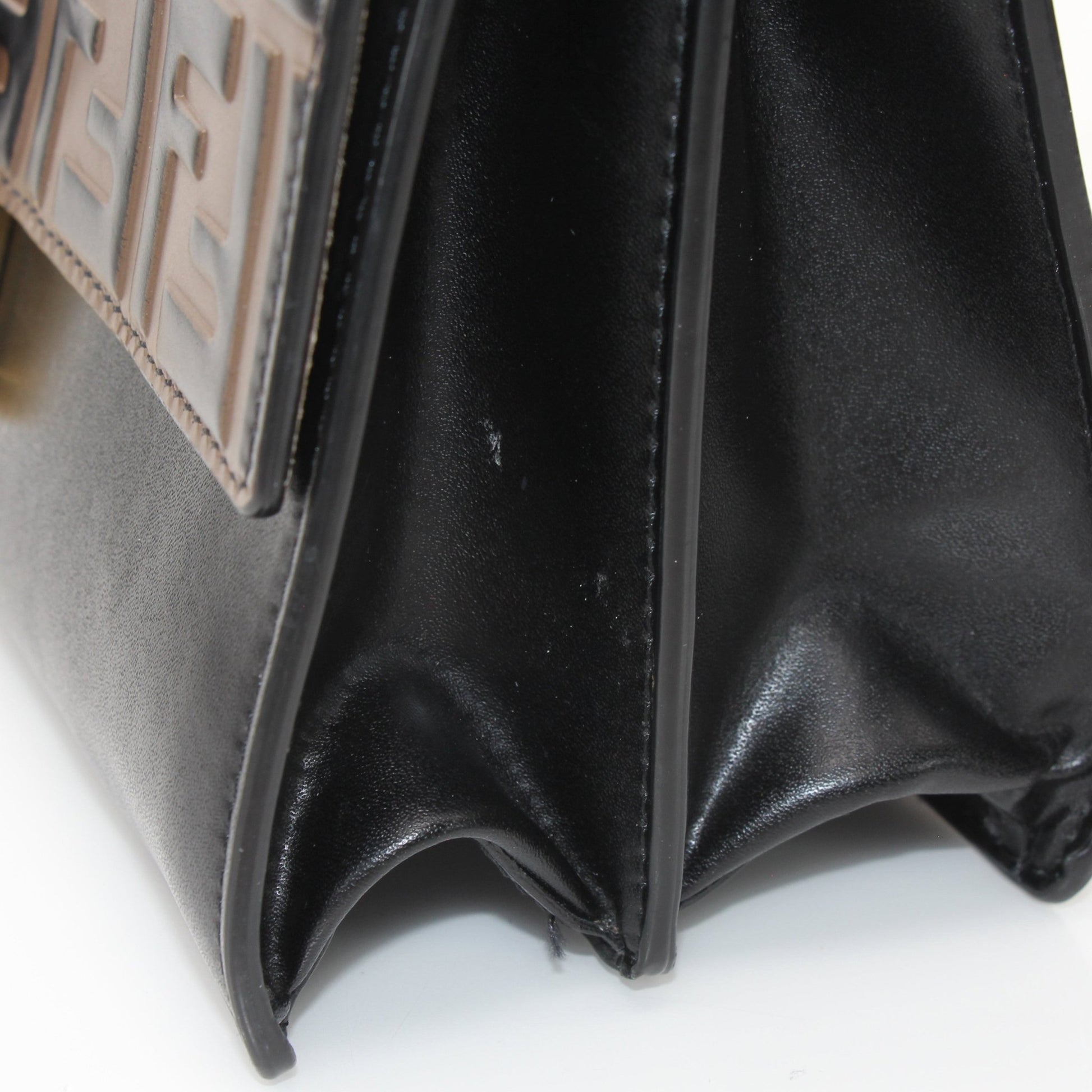 Fendi FF Kan shoulder handbag in beige and brown with gold hardware, featuring logo pattern and leather strap.