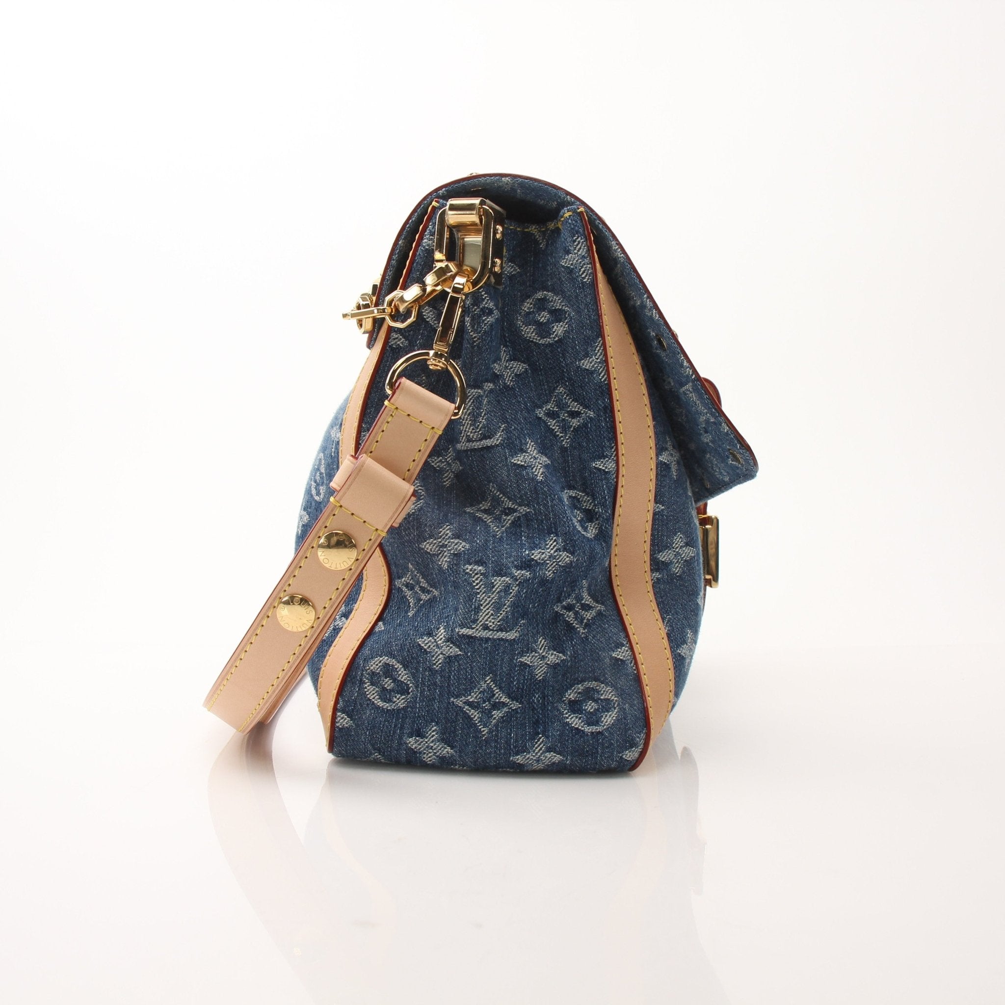 Louis Vuitton Dauphine GM shoulder handbag with gold hardware and leather strap, showcasing elegant design and branding.