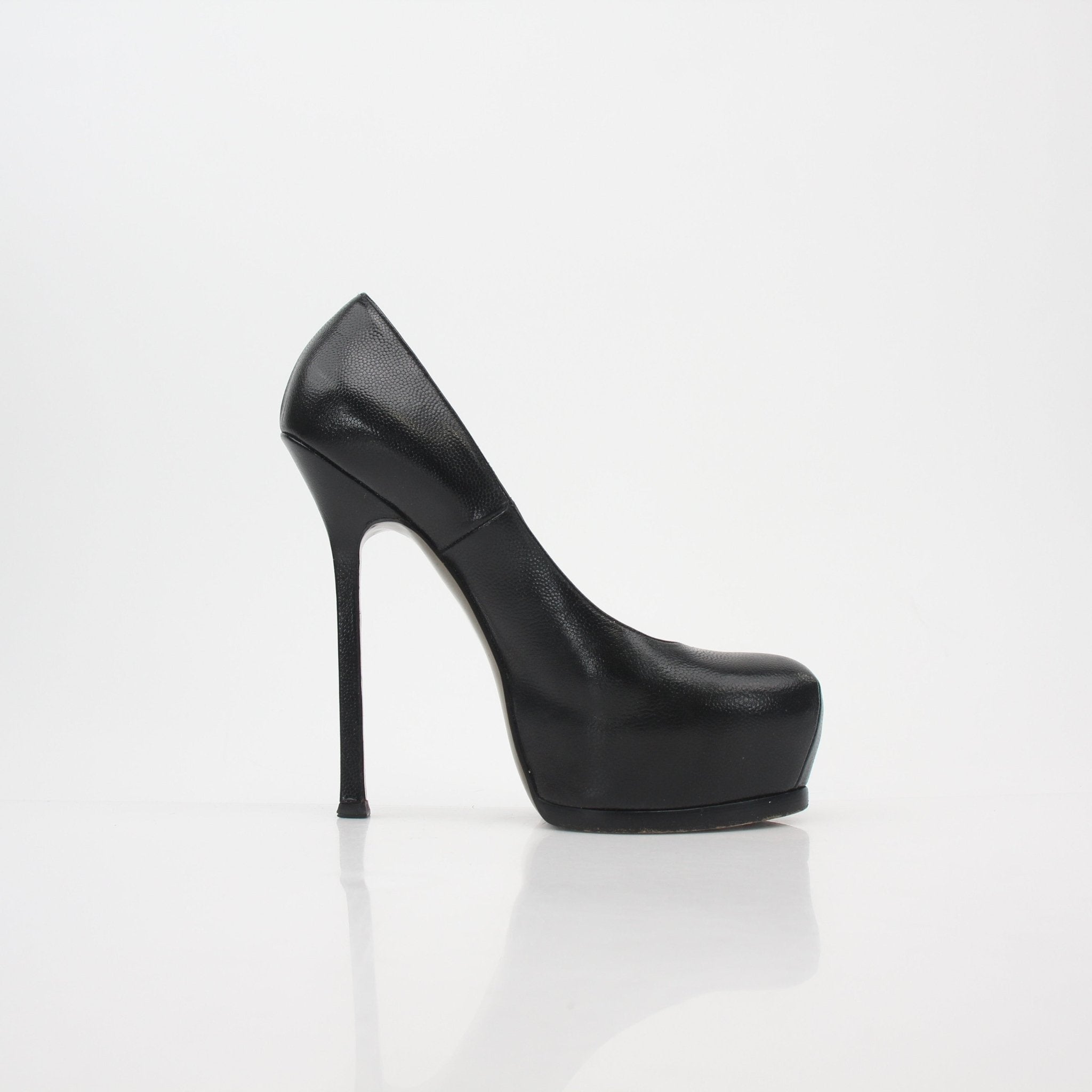 Black textured leather Saint Laurent Tribtoo platform pumps with stiletto heels, detailed design, and sleek finish.