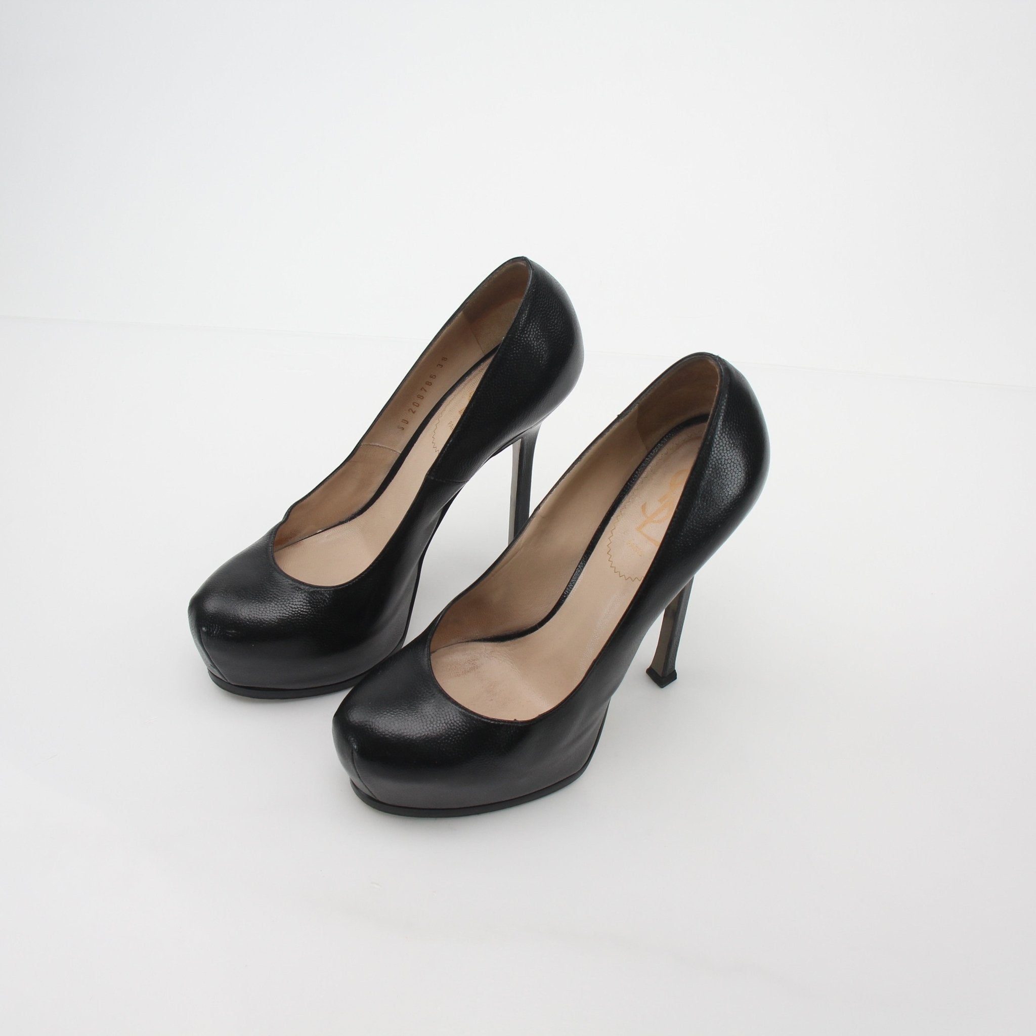 Black textured leather Saint Laurent Tribtoo platform heels with stiletto design and high heels, displayed on a white background.