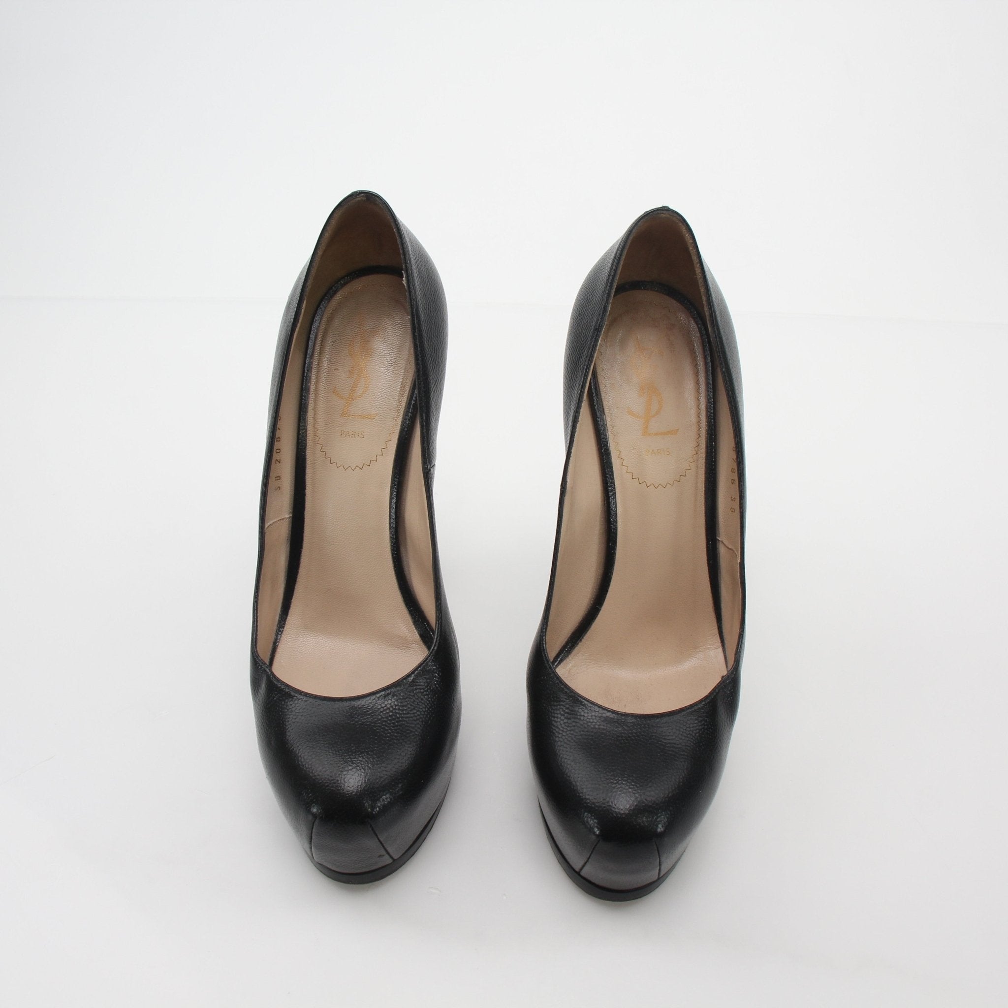Black textured leather Saint Laurent Tribtoo platform heels with chunky heels and sleek design, shown on a white background.