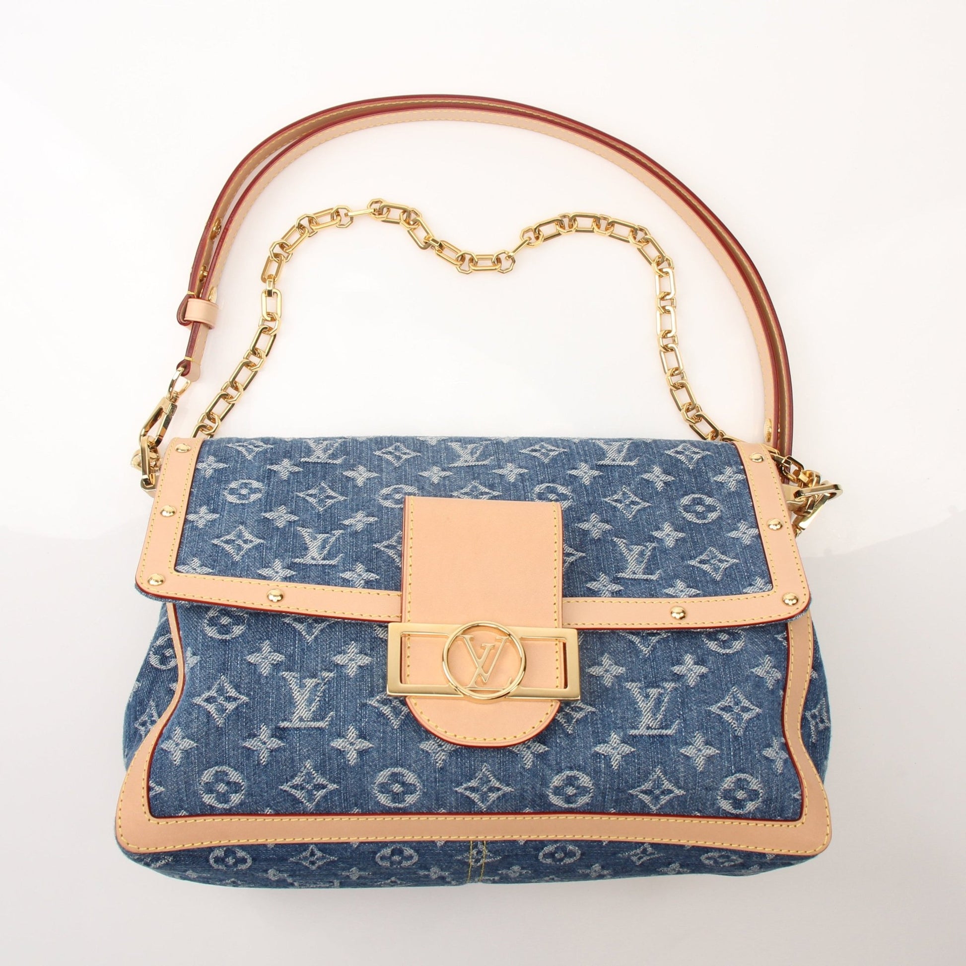 Gold & Beyond Louis Vuitton Dauphine GM shoulder handbag with structured design and gold-tone hardware, displayed on a neutral background.