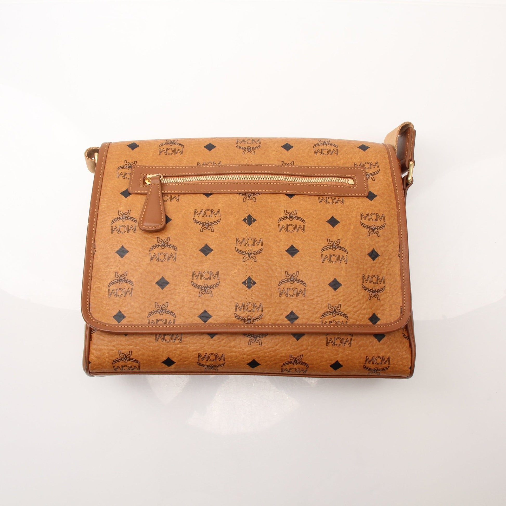Gold & Beyond MCM Aren Messenger Bag handbag with signature monogram pattern and leather accents, displayed on a neutral background.