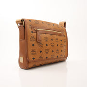 Gold & Beyond MCM Aren Messenger Bag handbag with tan leather and silver hardware, featuring adjustable strap and signature logo accents.