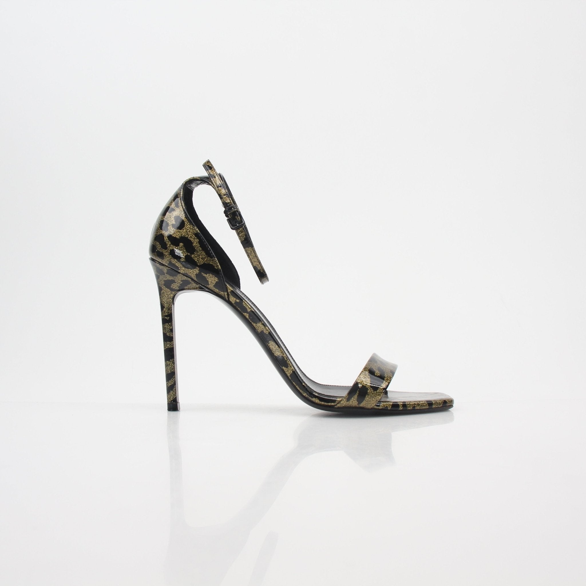 Saint Laurent black and gold amber ankle-strap heels by Gold & Beyond, showcasing elegant sandal design with metallic accents