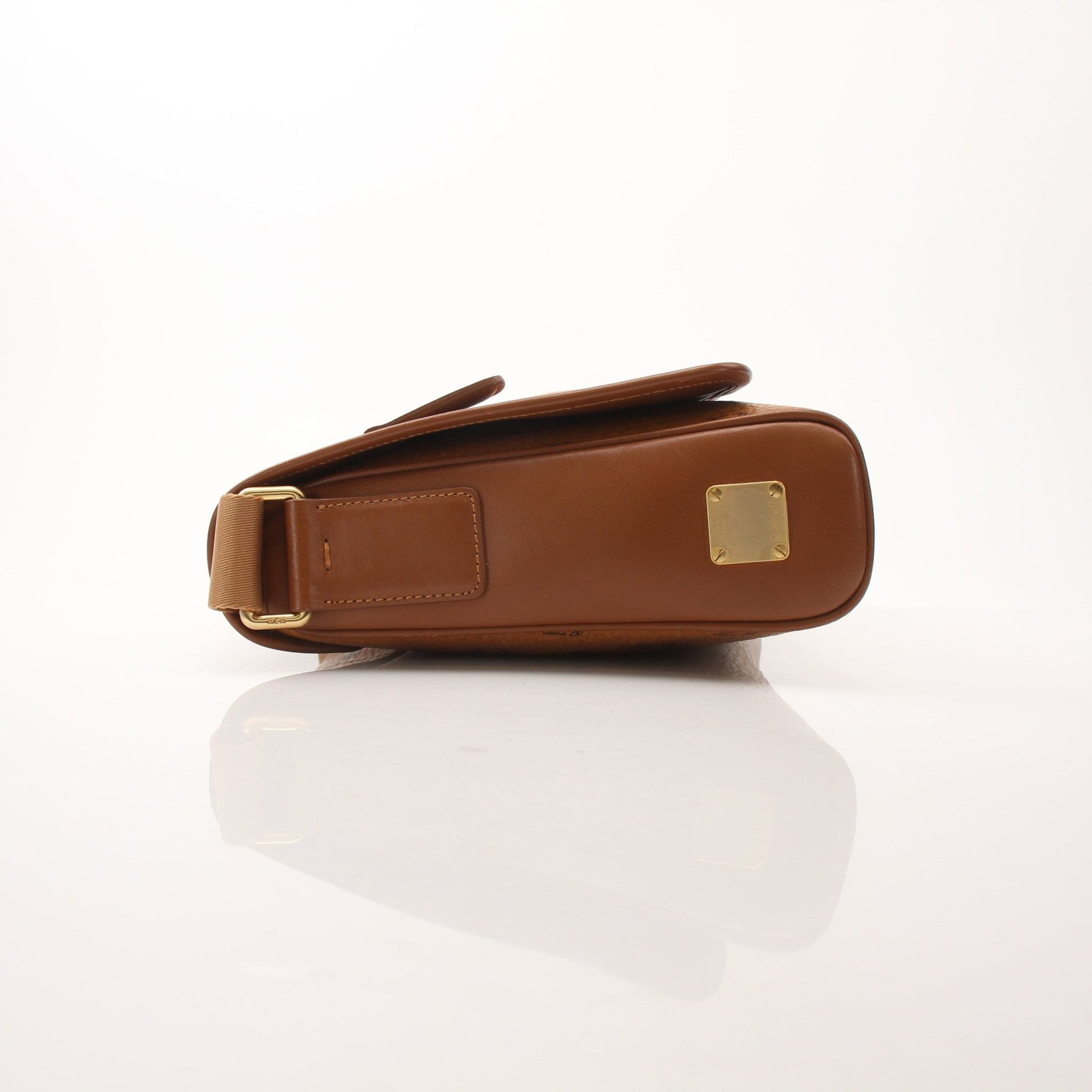Gold & Beyond MCM Aren Messenger Bag handbag with logo embossing and adjustable strap, shown in a close-up view.