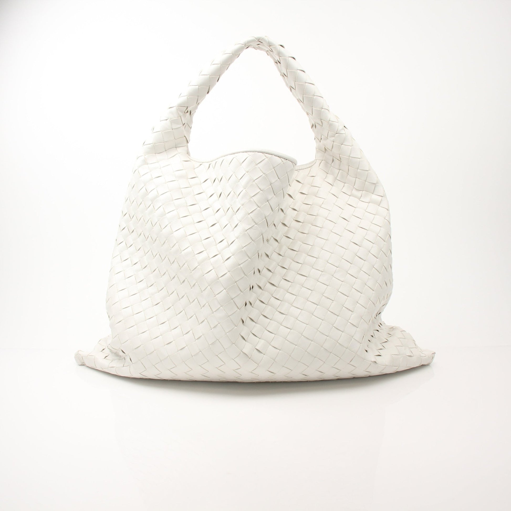 Large white Bottega Veneta Intrecciato leather hobo handbag with slouchy design and top handle, showing textured woven pattern.