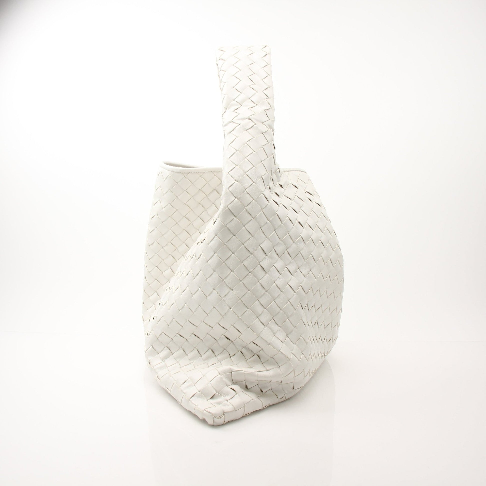Large white Bottega Veneta Intrecciato leather hobo bag with spacious design and woven texture, shown on a plain background.
