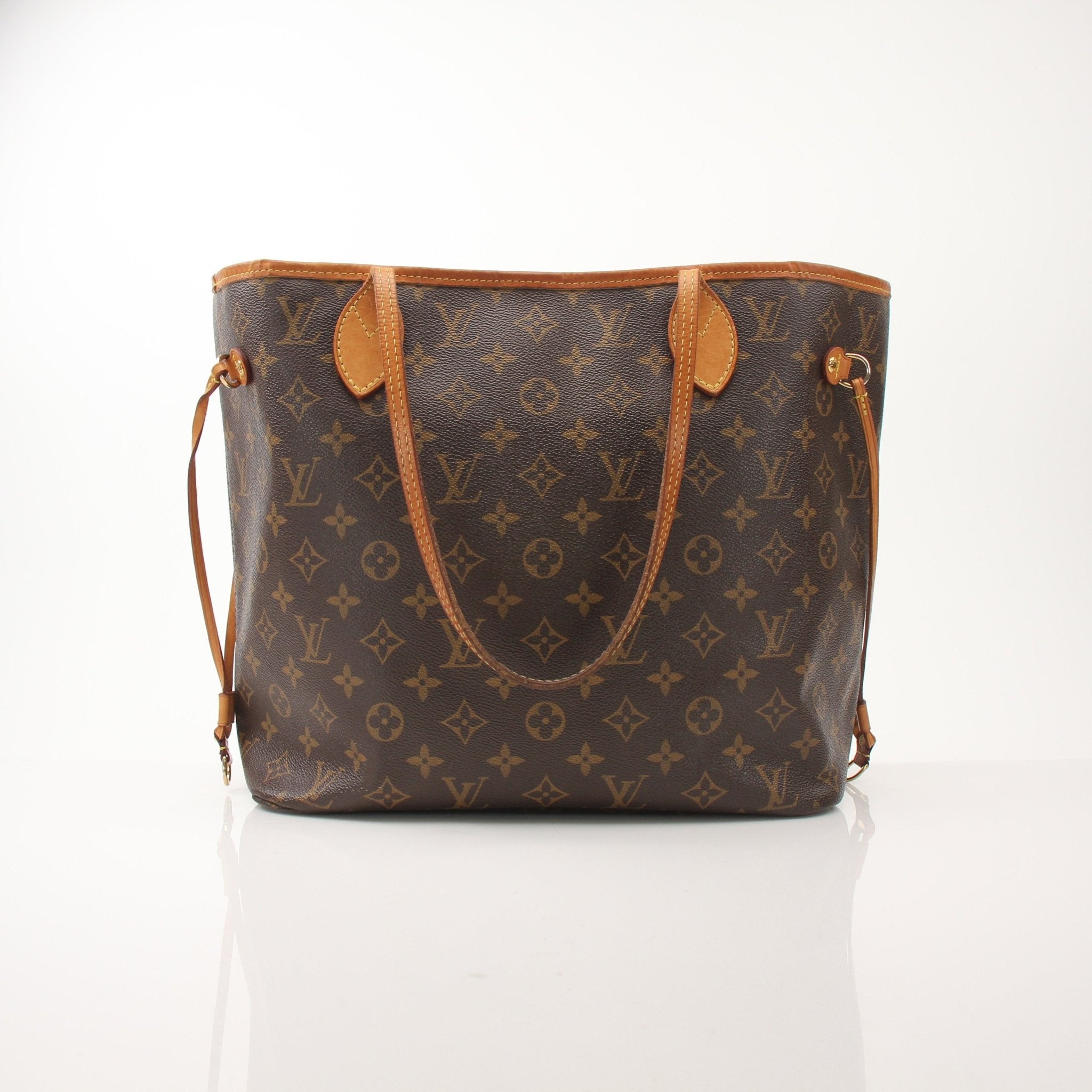 Louis Vuitton Neverfull MM tote handbag with signature monogram canvas and tan leather trim, displayed on a neutral background.
