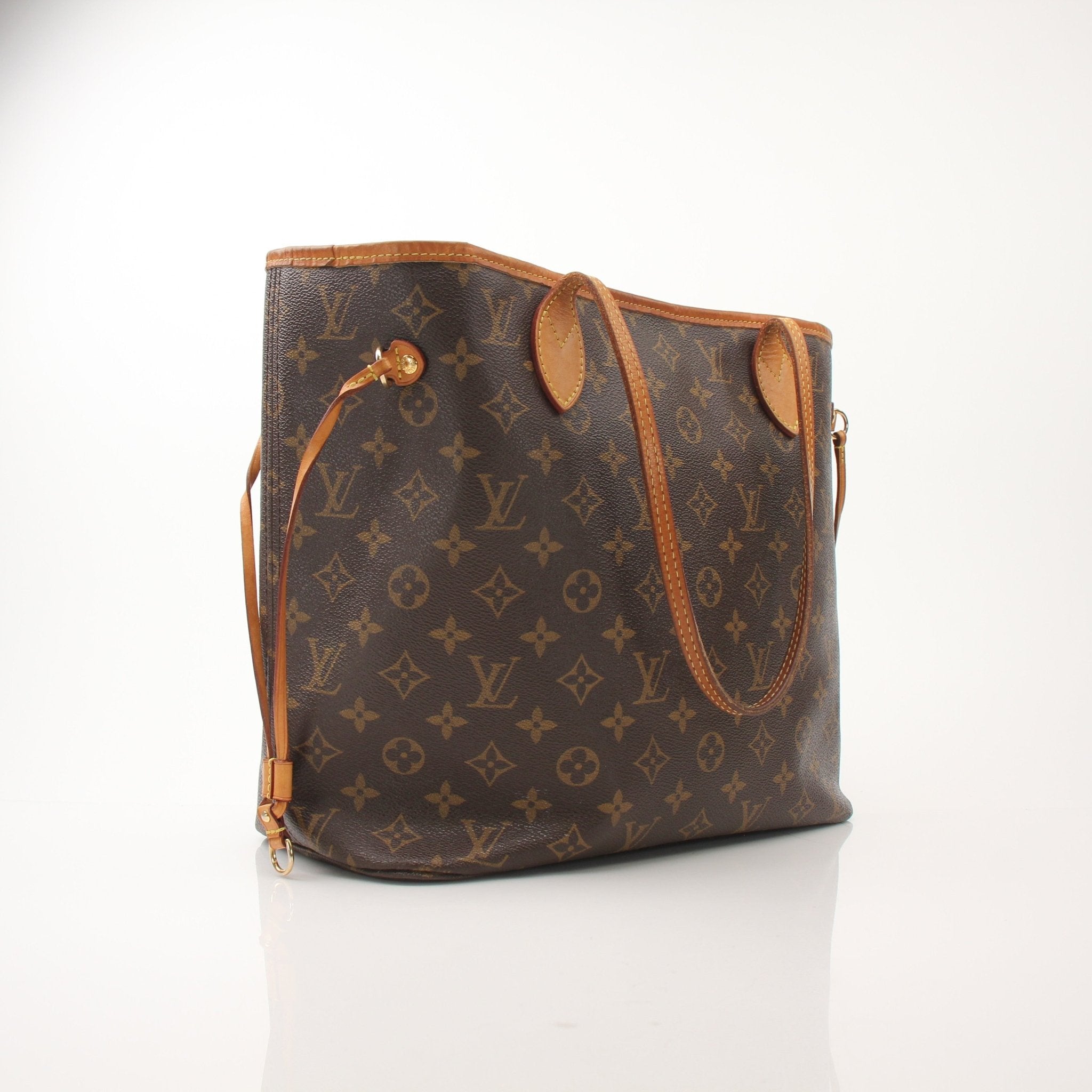 Louis Vuitton Neverfull MM tote handbag with leather trim and signature monogram pattern, displayed on a neutral background.