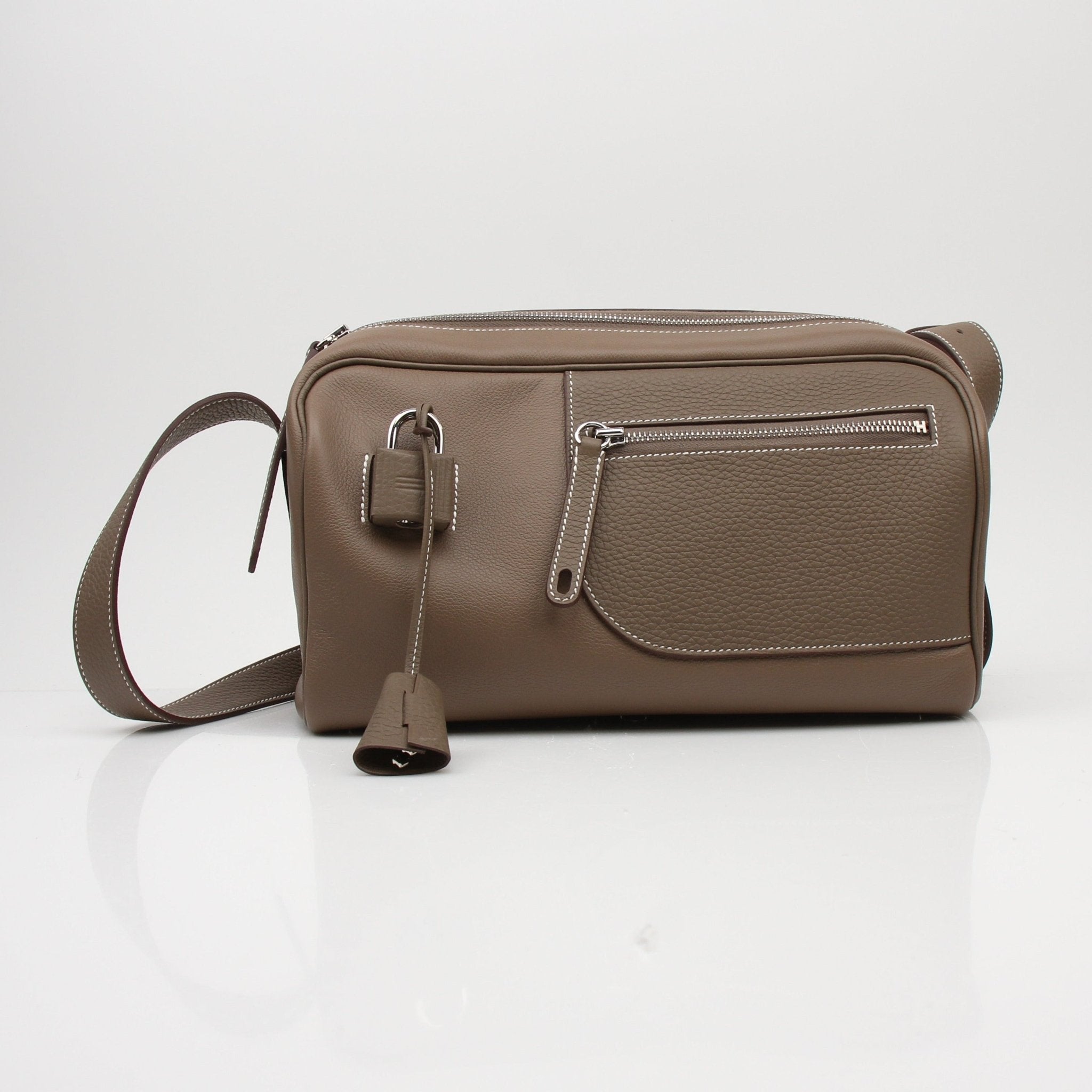 Gold & Beyond Hermès Petite Courrier handbag, stylish leather bag with top handle and compact design, in natural light.
