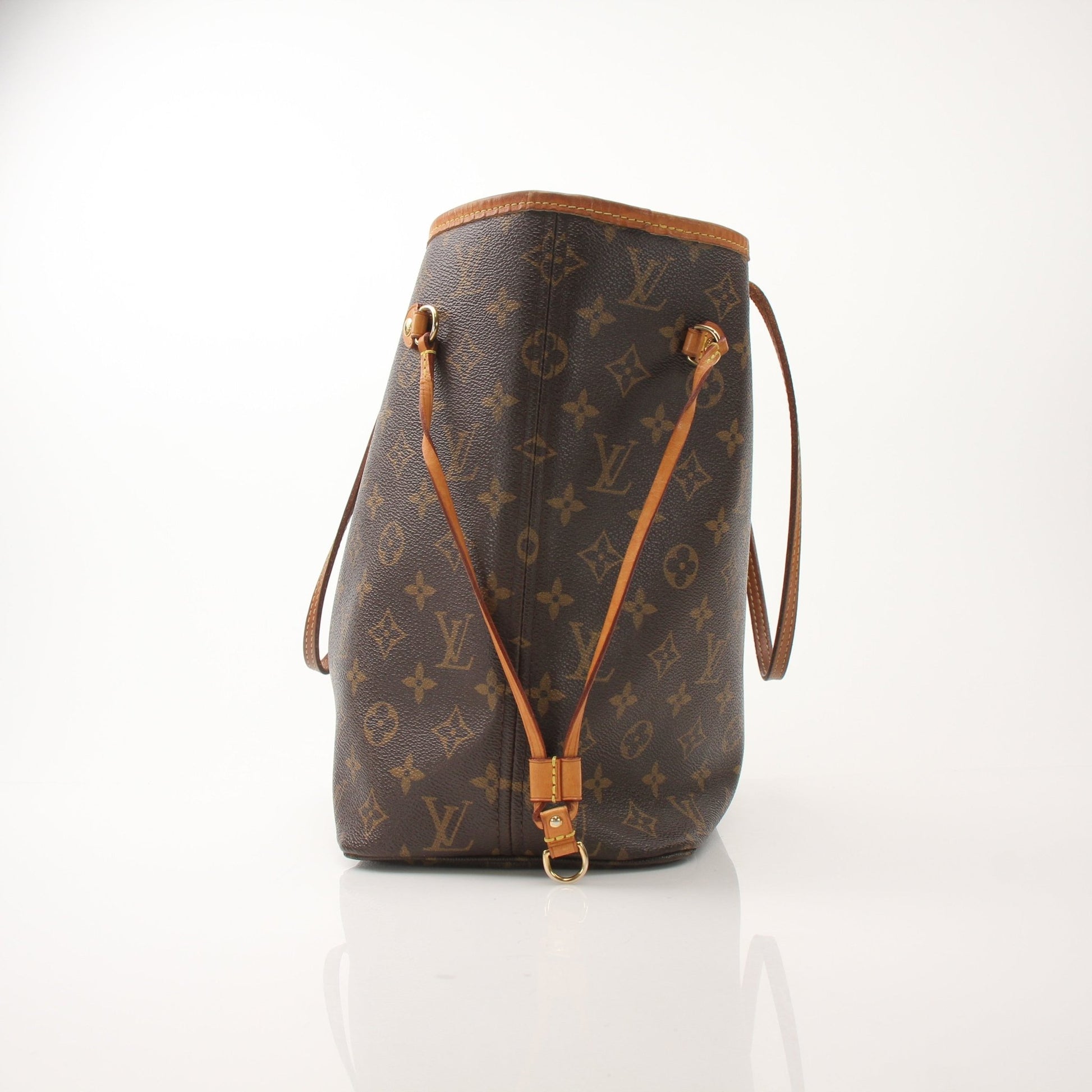Louis Vuitton Neverfull MM tote handbag with tan leather straps and monogram canvas, displayed on a neutral background.