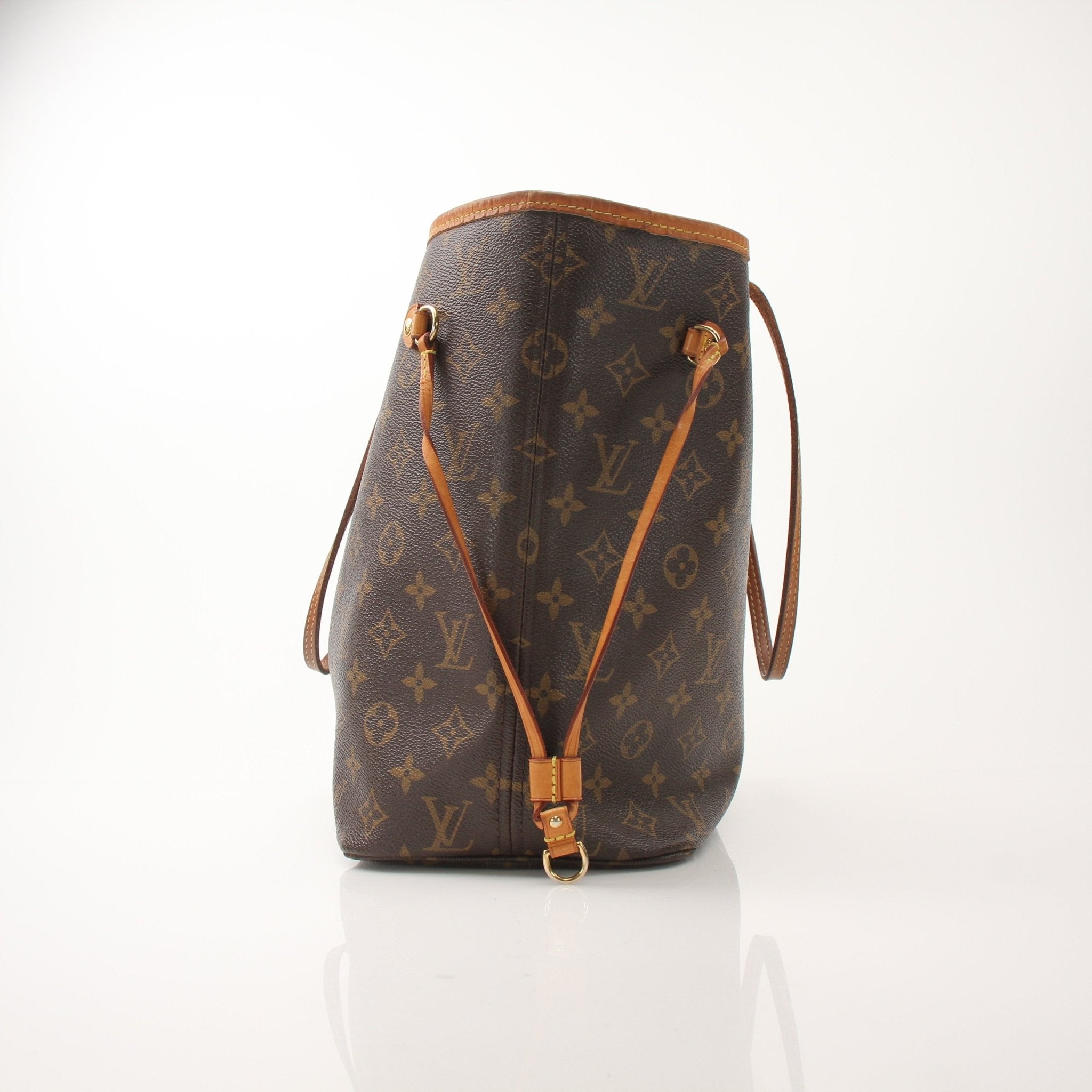 Louis Vuitton Neverfull MM tote handbag with tan leather straps and monogram canvas, displayed on a neutral background.