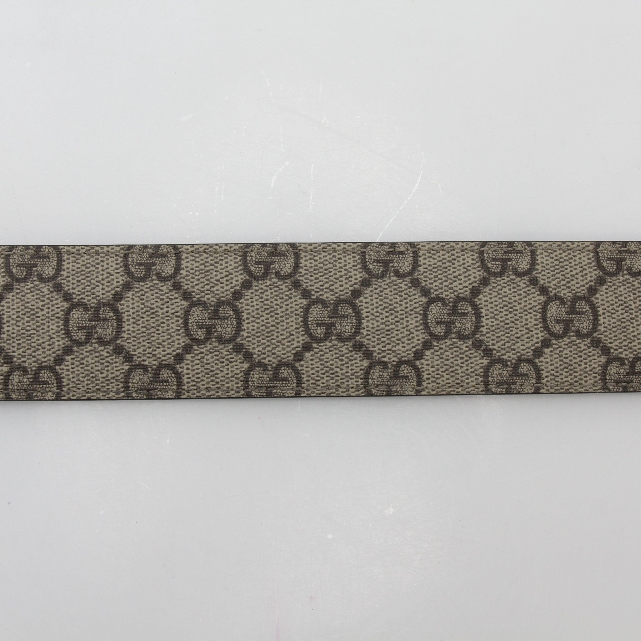 Gucci beige ebony GG Supreme Interlocking G belt with gold buckle, stylish accessories for men and women.