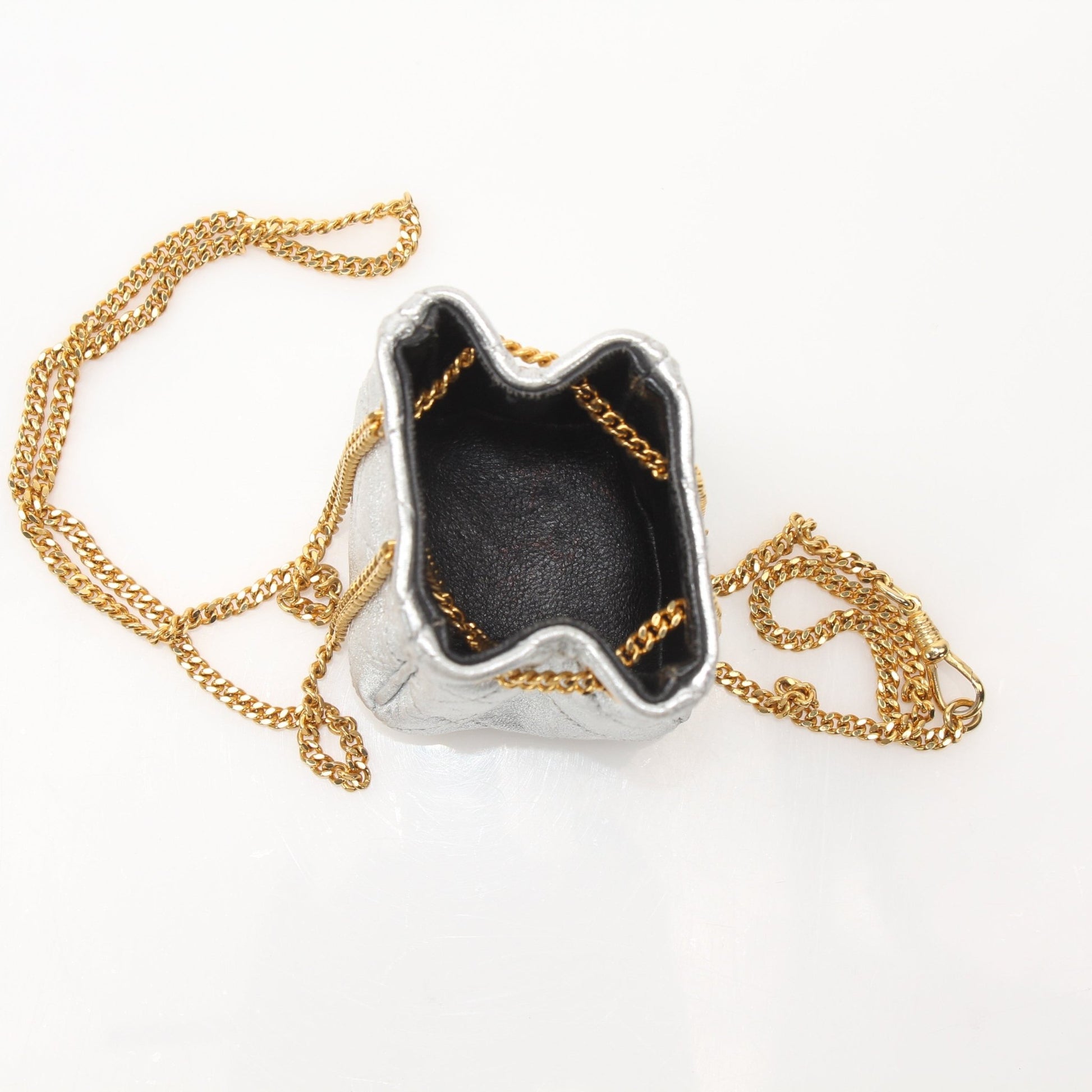 Gold & Beyond Chanel micro quilted drawstring pouch, stylish accessories with quilted pattern and drawstring closure.