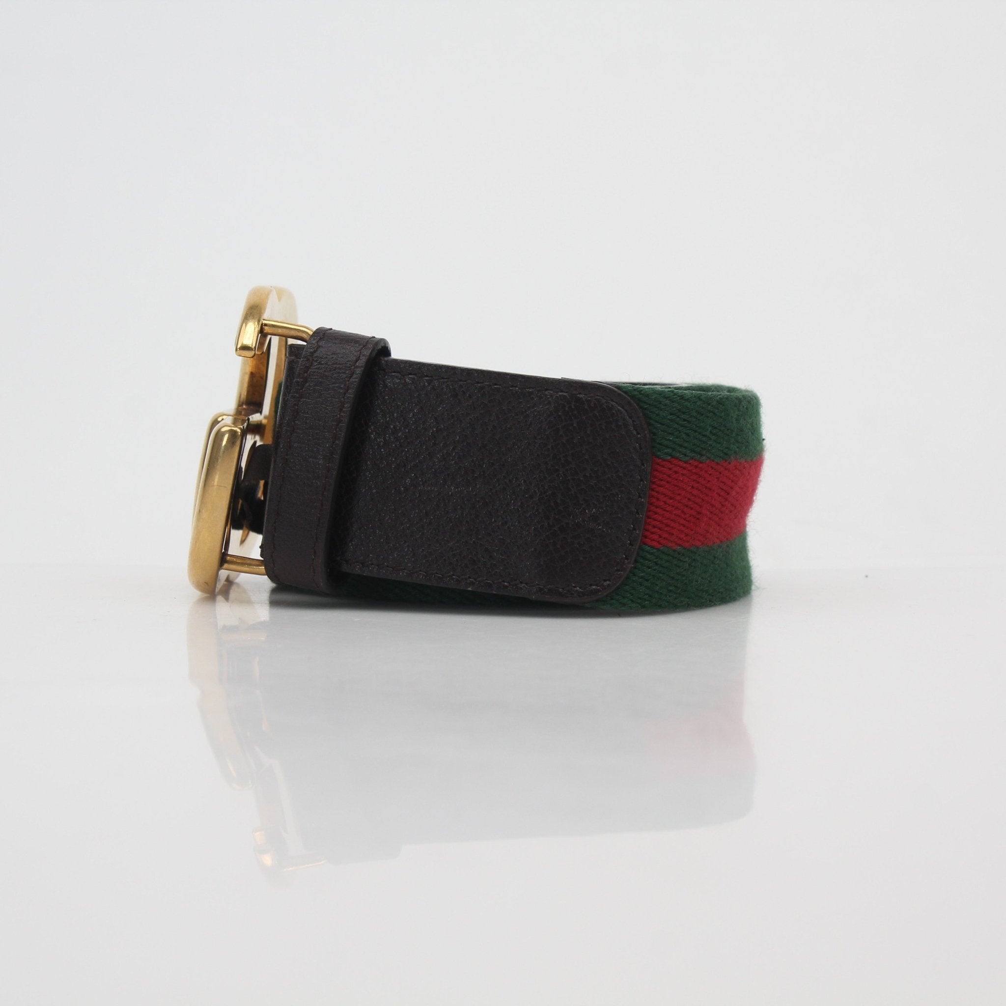 Gucci Green and Red Web GG Marmont belt featuring gold-tone hardware, designed as a stylish accessory for fashion-conscious individuals.
