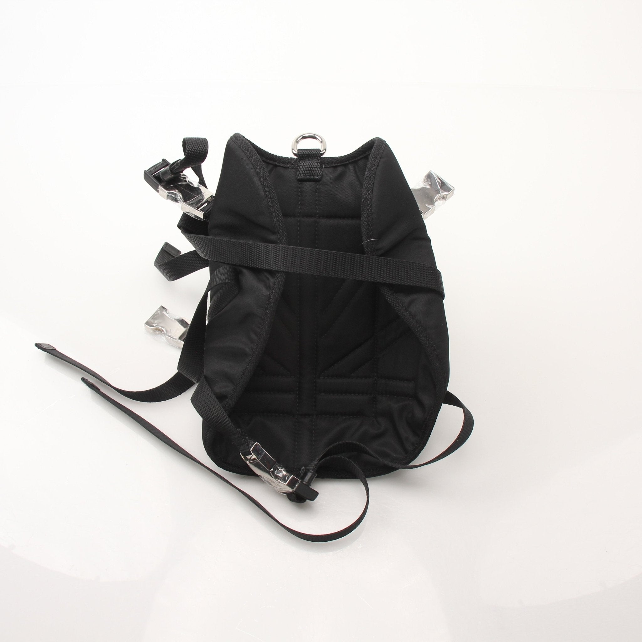 Black nylon Prada dog harness with adjustable straps and metal buckles, designed for comfort and style in accessories.
