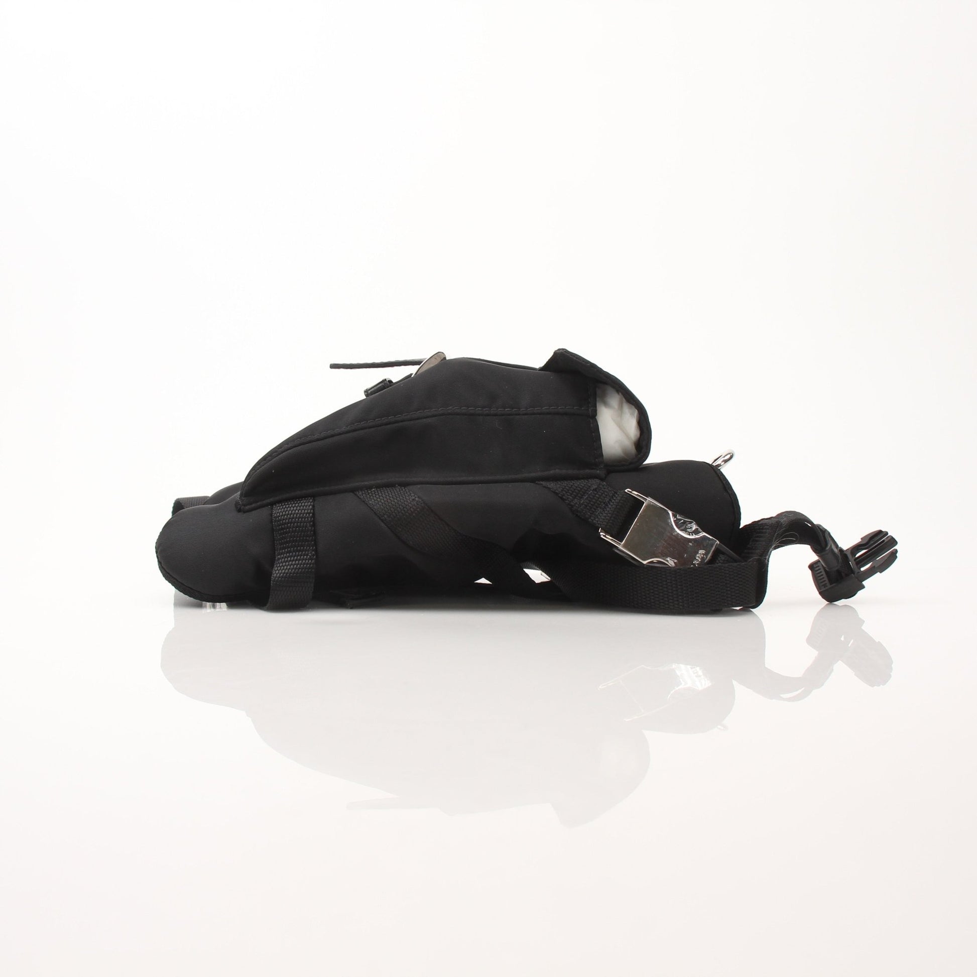 Black nylon dog harness from Prada accessories collection, featuring adjustable straps and metal hardware for a secure fit.