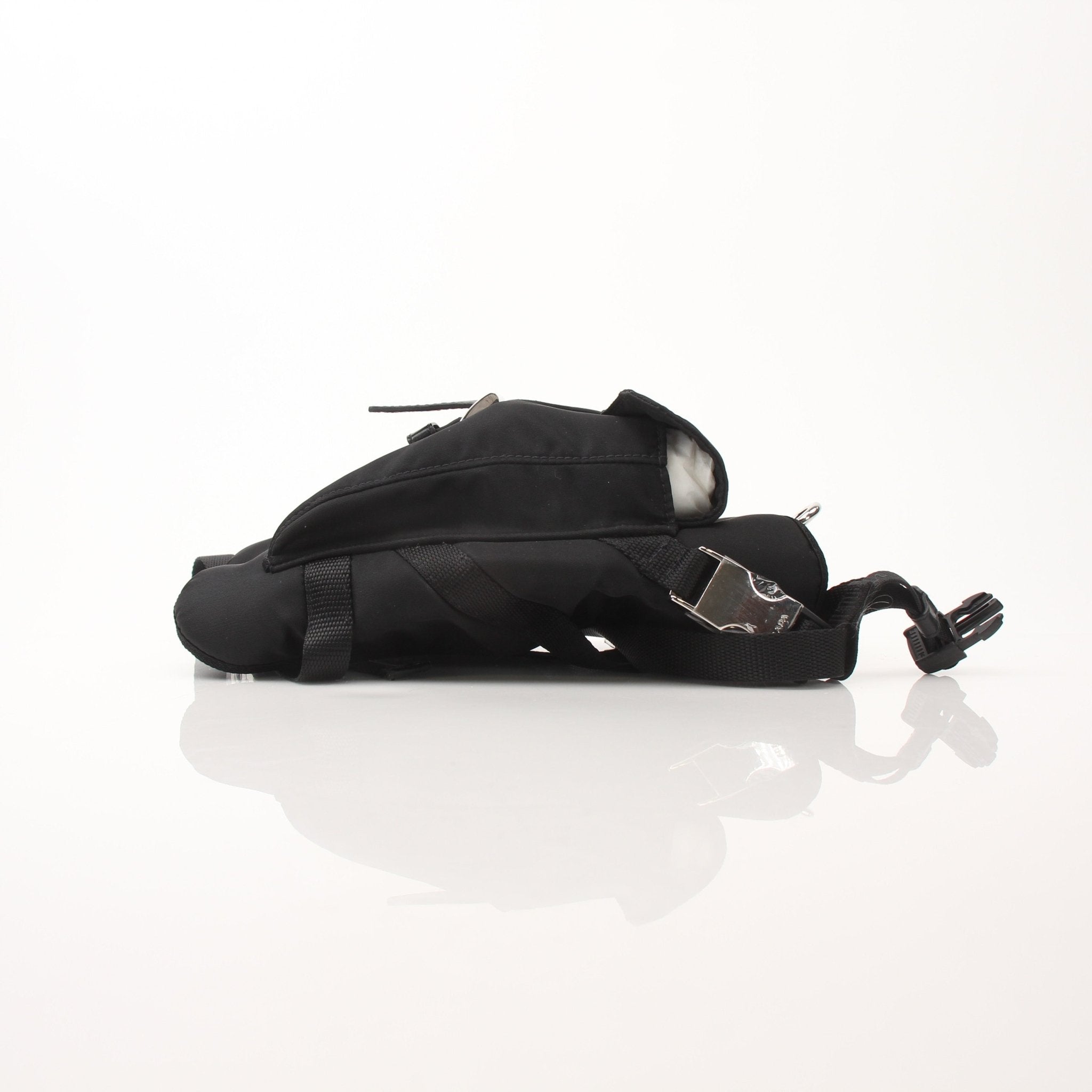 Black nylon dog harness from Prada accessories collection, featuring adjustable straps and metal hardware for a secure fit.