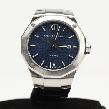 Baume & Mercier Riviera Automatic watch featuring a blue dial and stainless steel case on a white background.