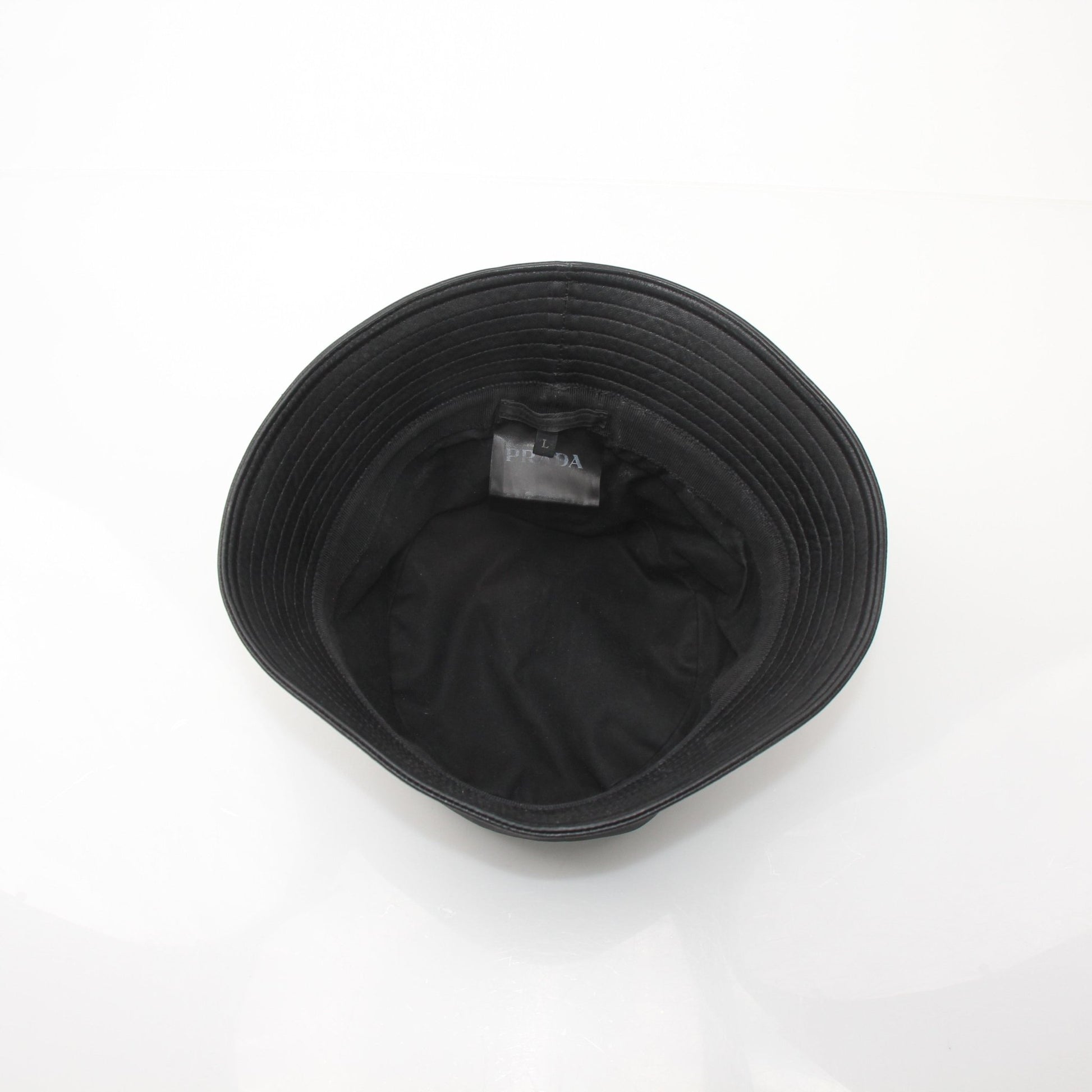 Black Prada Nappa leather bucket hat, stylish accessories from Gold & Beyond, featuring smooth leather and a classic bucket hat design.