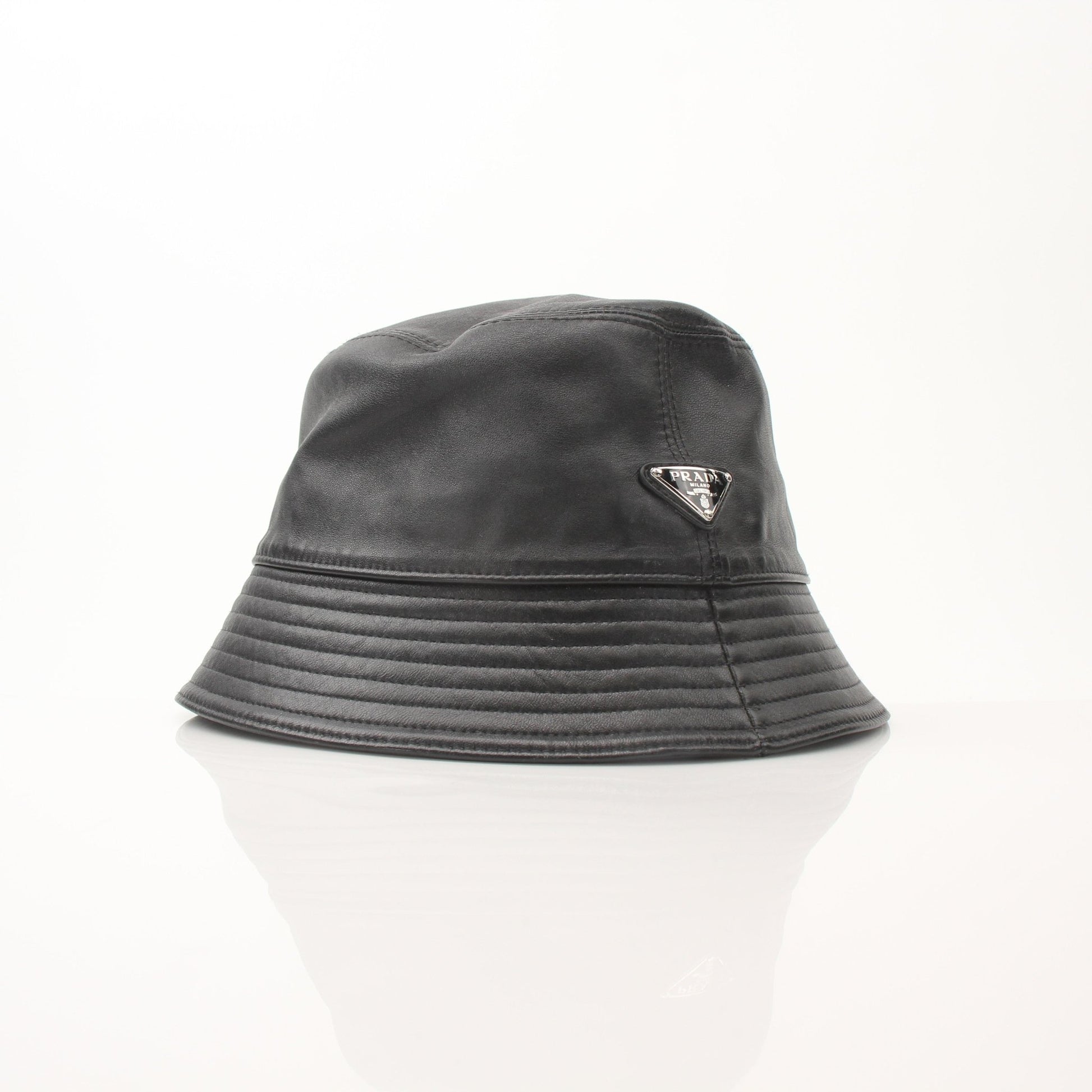 Prada black nappa leather bucket hat, luxury accessories, shown with a wide brim and smooth leather texture.