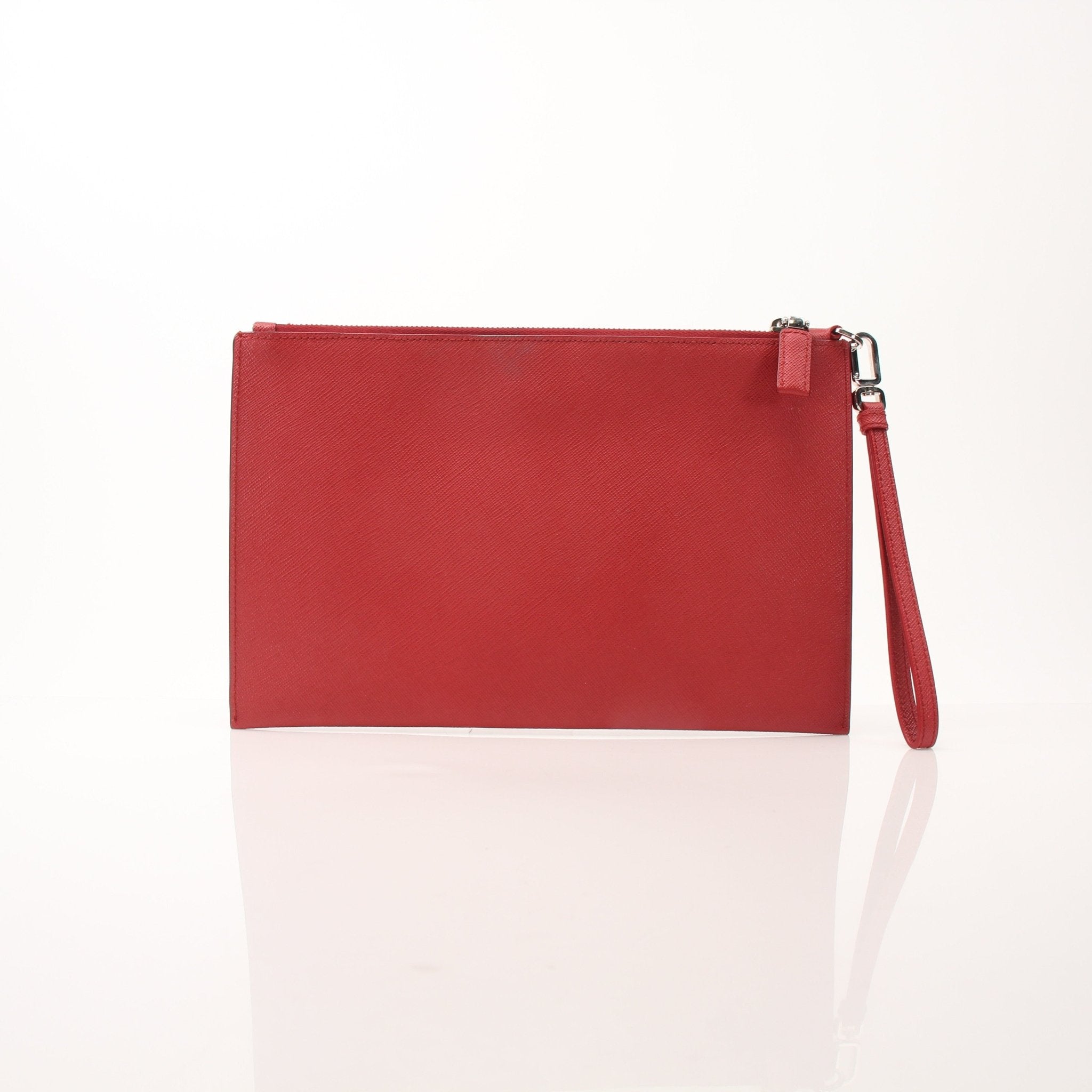 Red Prada Saffiano leather wristlet pouch with gold-tone hardware, featuring a sleek, compact design and a wrist strap for easy carrying.