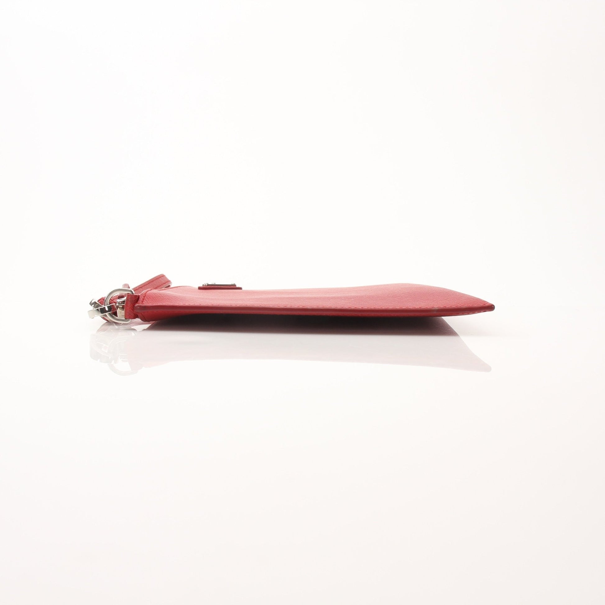 Red Prada Saffiano leather wristlet pouch, elegant handbag with gold hardware, designed for stylish carrying and organization.