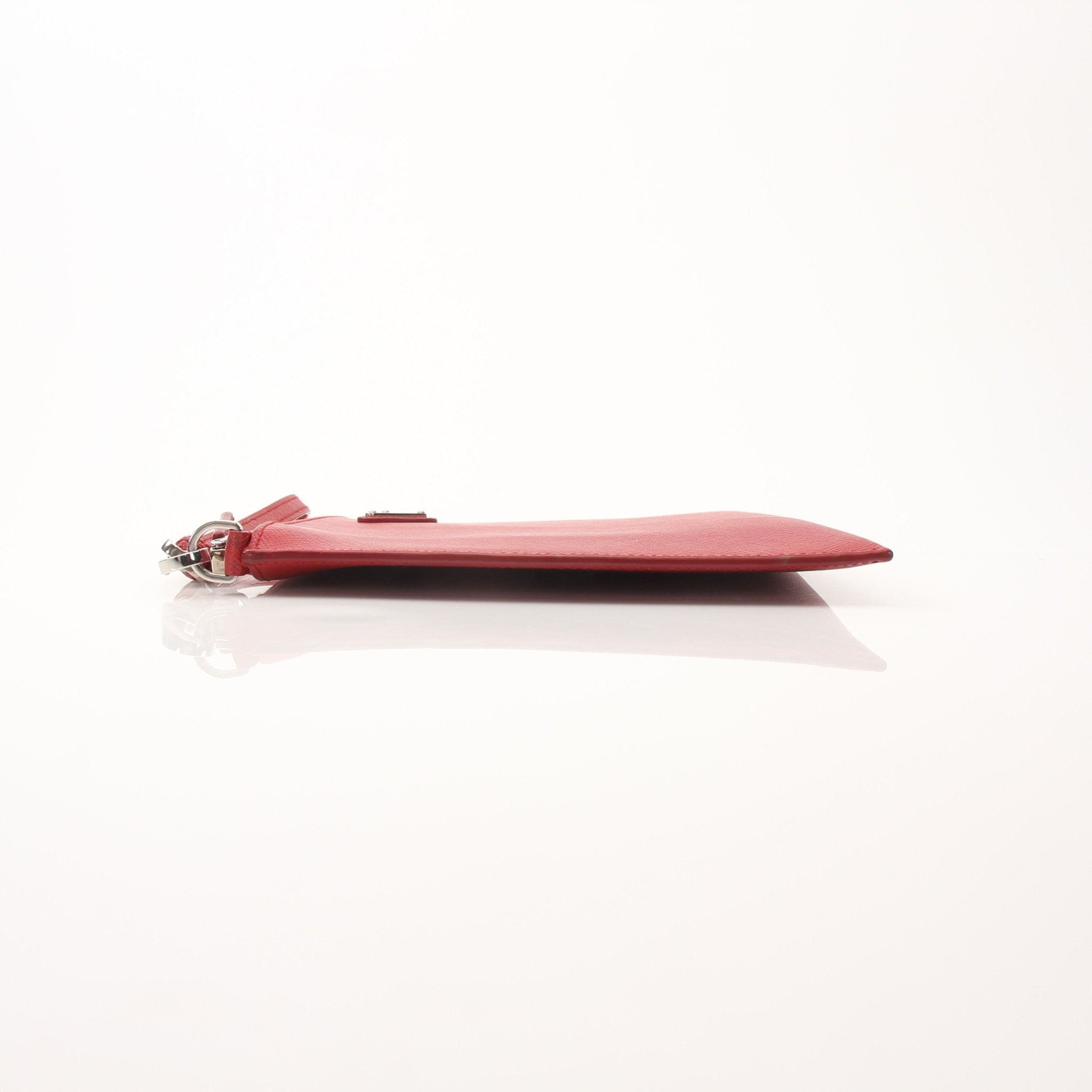 Red Prada Saffiano leather wristlet pouch, elegant handbag with gold hardware, designed for stylish carrying and organization.