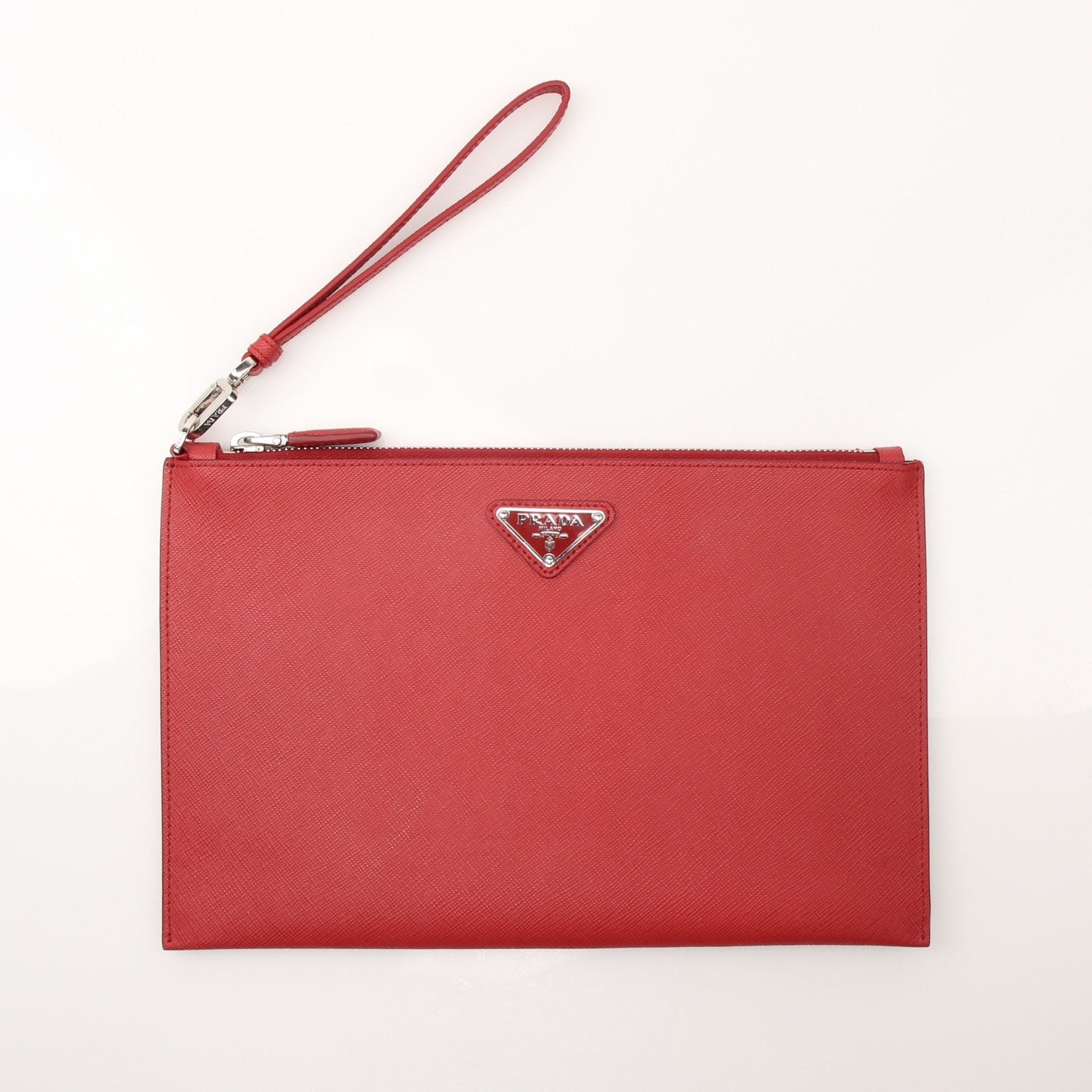 Prada red saffiano leather wristlet pouch with gold hardware, compact handbag for essentials, shown on a white background.