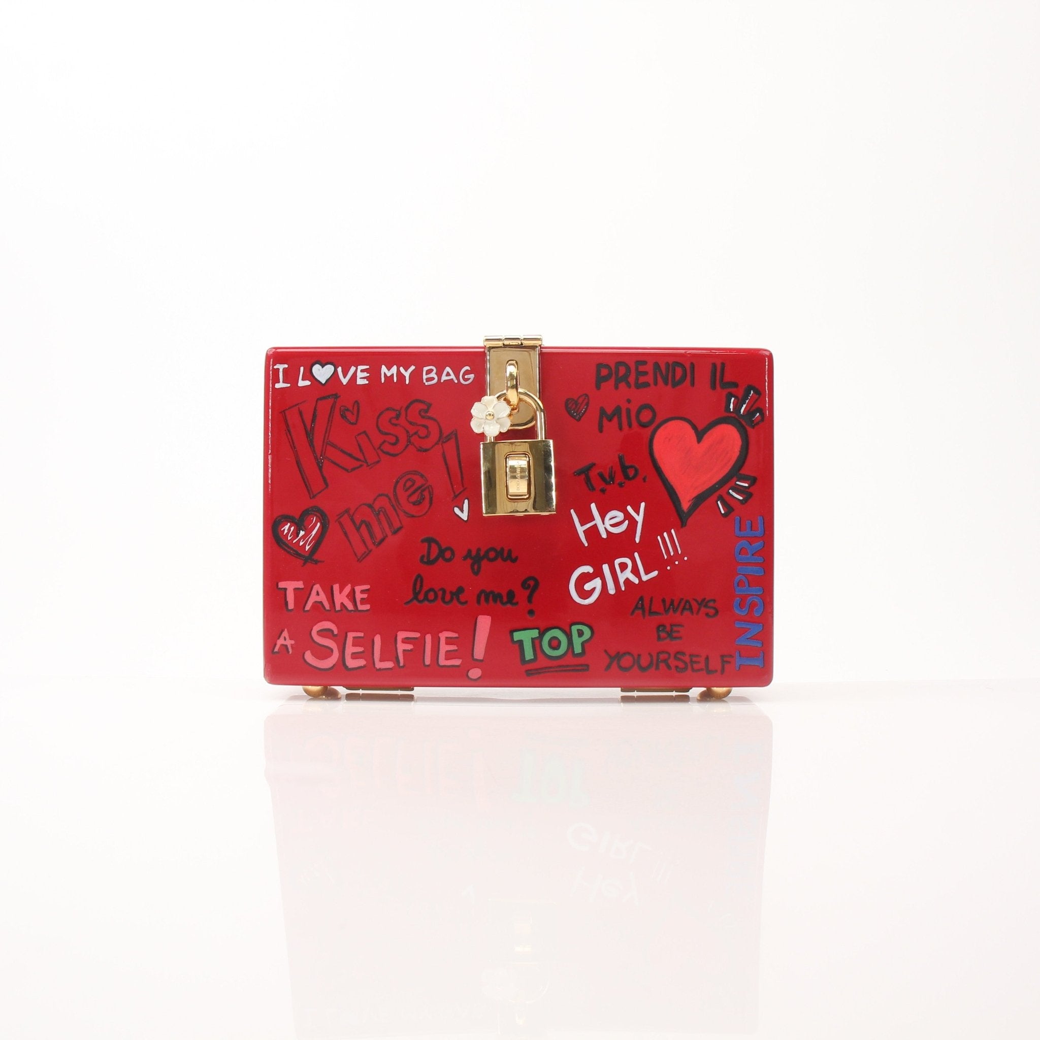 Dolce & Gabbana red graffiti box clutch handbag with gold accents, featuring a bold, artistic design and structured shape.