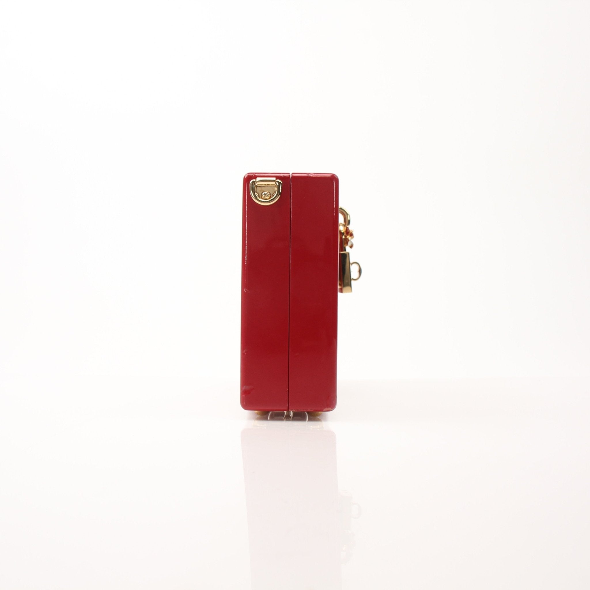 Red graffiti Dolce & Gabbana box clutch handbag with gold accents, featuring bold artistic design and compact shape.