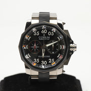 Corum Admiral’s Cup Chronograph watch with a stainless steel case, black dial, and multiple sub-dials, on a metal bracelet.
