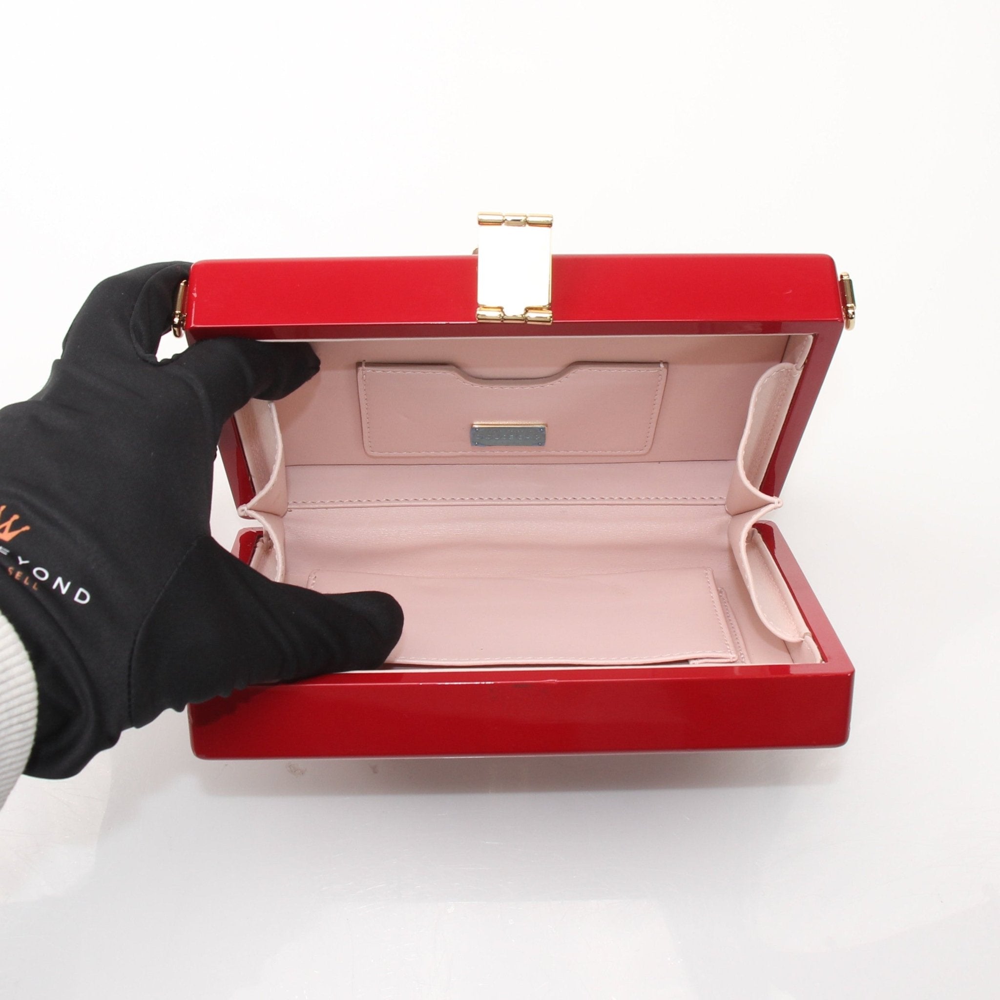Red graffiti design Dolce & Gabbana box clutch handbag with gold accents, stylish and compact for elegant occasions.