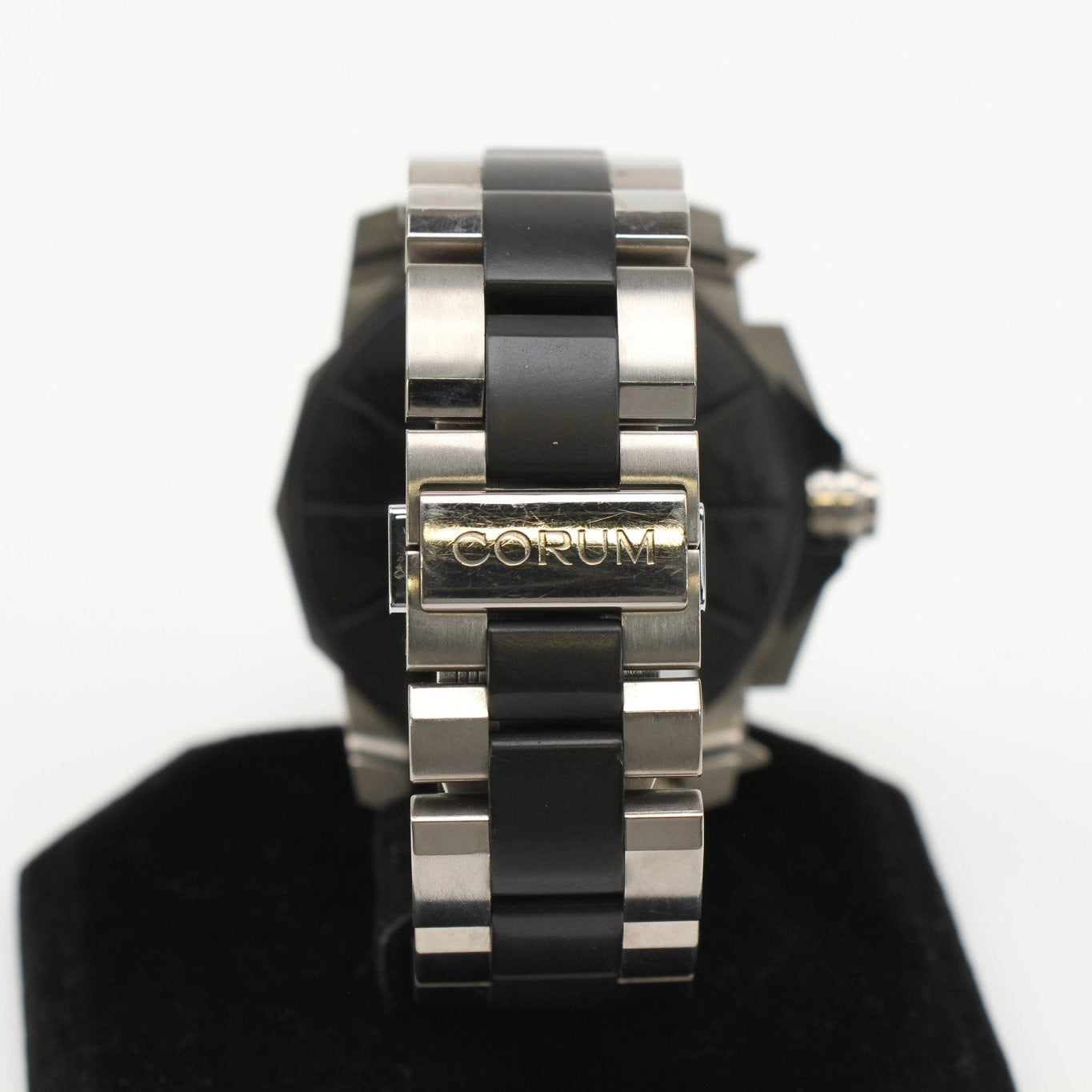 Corum Admiral’s Cup chronograph watch with stainless steel case, black dial, and silver-tone subdials, displayed on a white background.