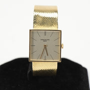 Gold & Beyond Patek Philippe square dress watch with gold case and leather strap, showcasing elegant design and classic style.