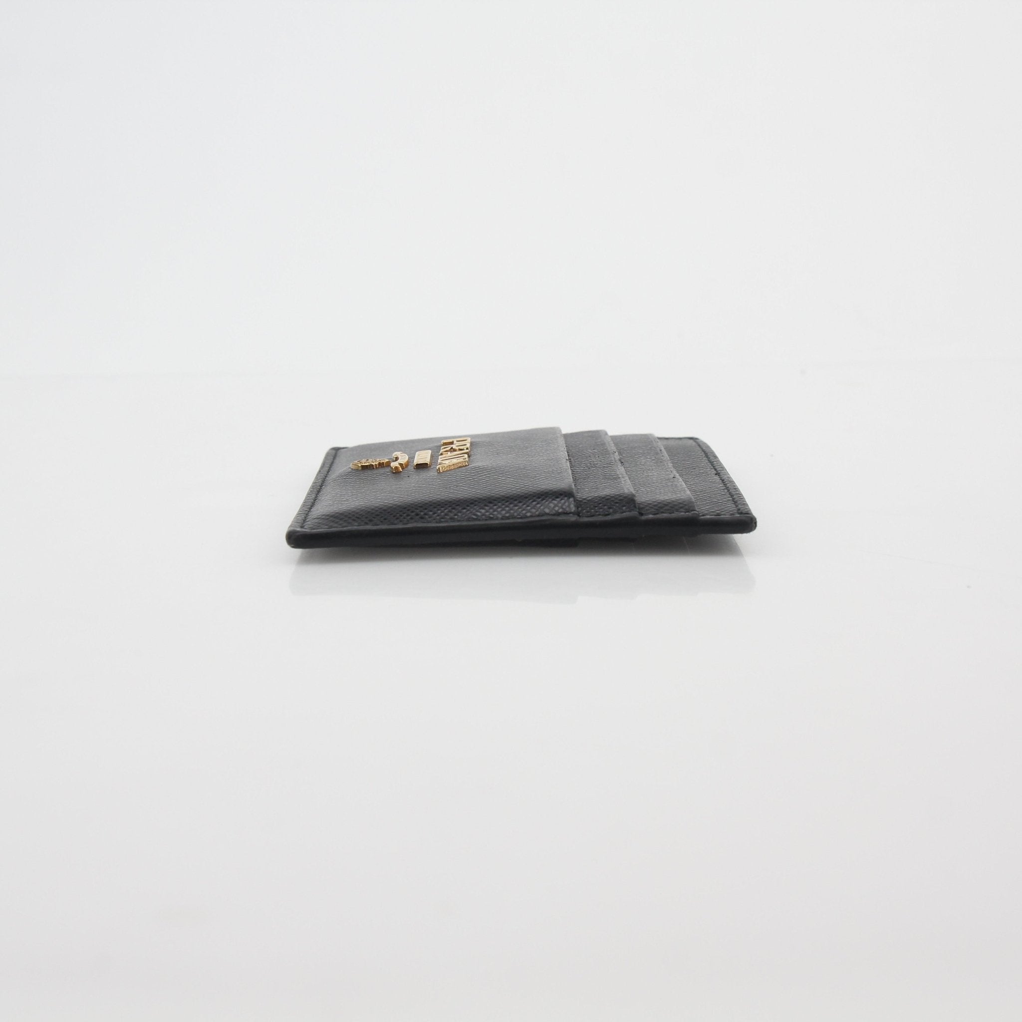 Prada black saffiano leather card holder with multiple card slots, compact and stylish accessory for everyday use.