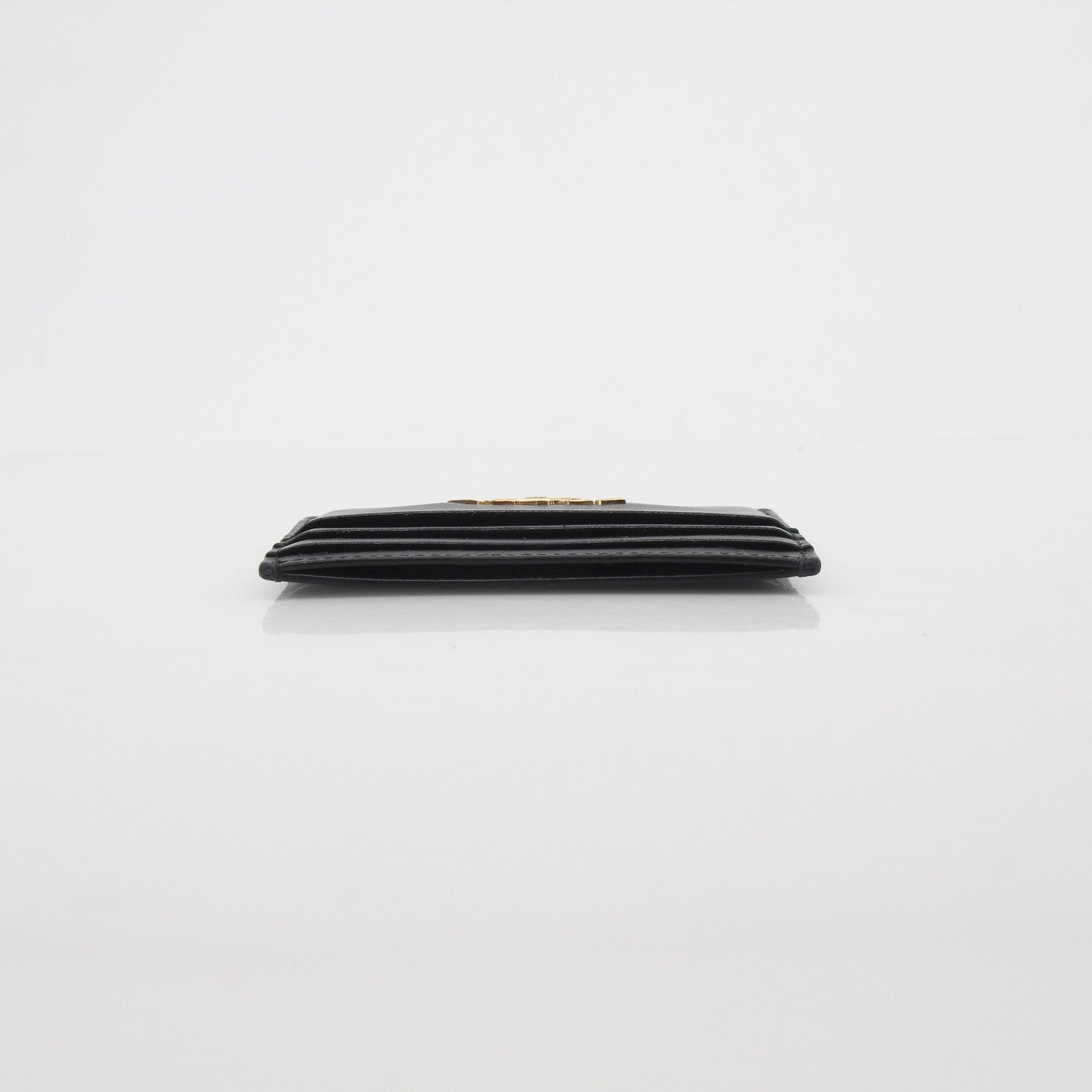 Prada black saffiano leather card holder with multiple card slots, compact and stylish for everyday use.