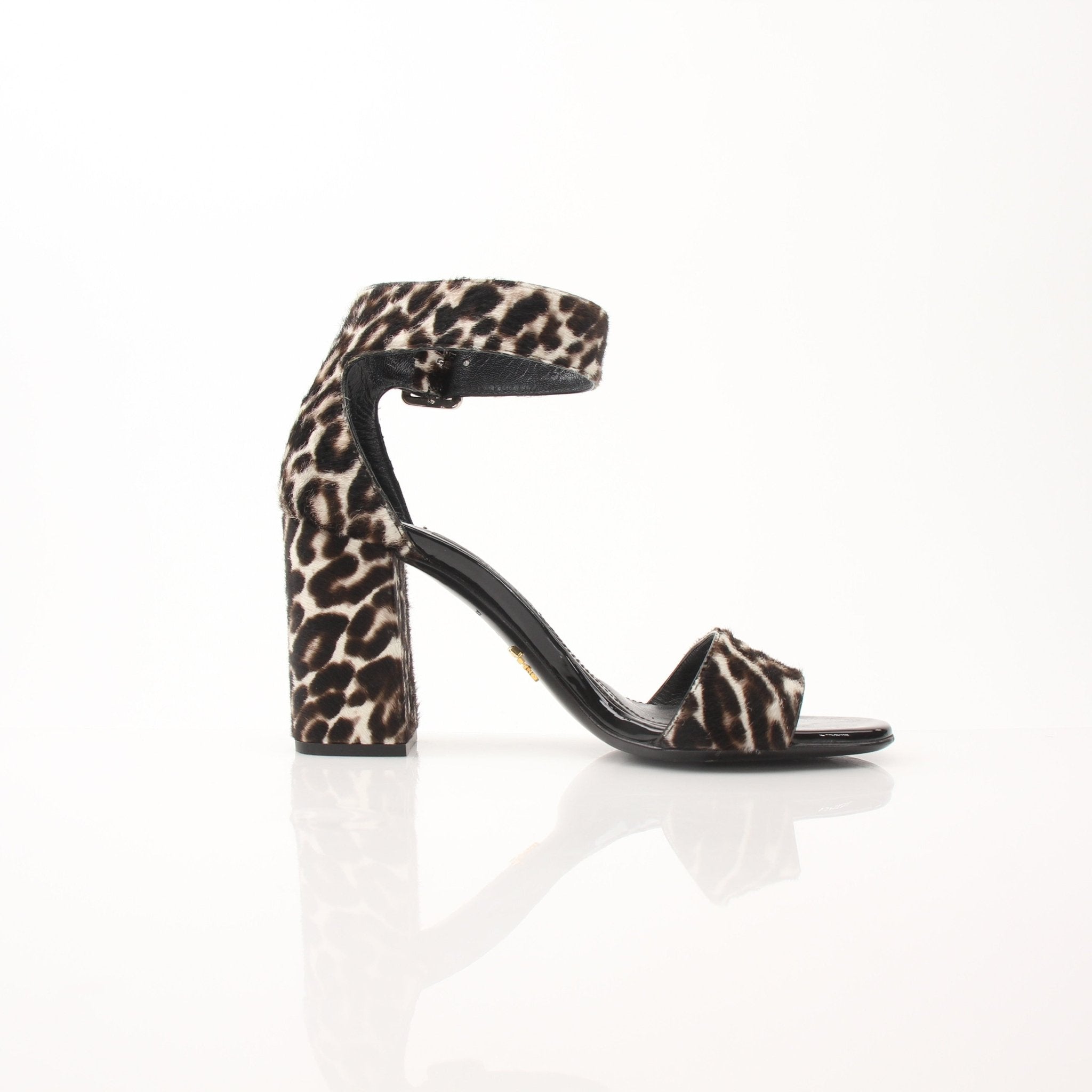 Prada pony hair leopard print block heel sandals with ankle straps, featuring a stylish and bold footwear design.