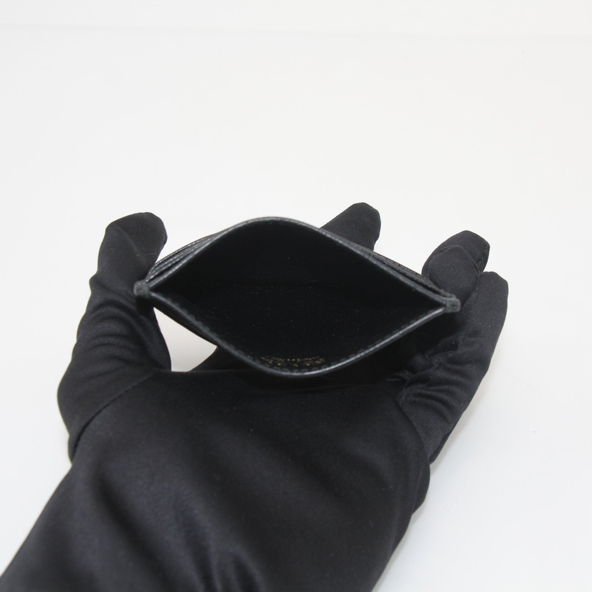 Prada black saffiano leather card holder with multiple card slots, compact and stylish for everyday use.
