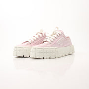 Prada pink nylon double wheel platform sneakers, stylish shoes with chunky soles and vibrant color, on a plain background.