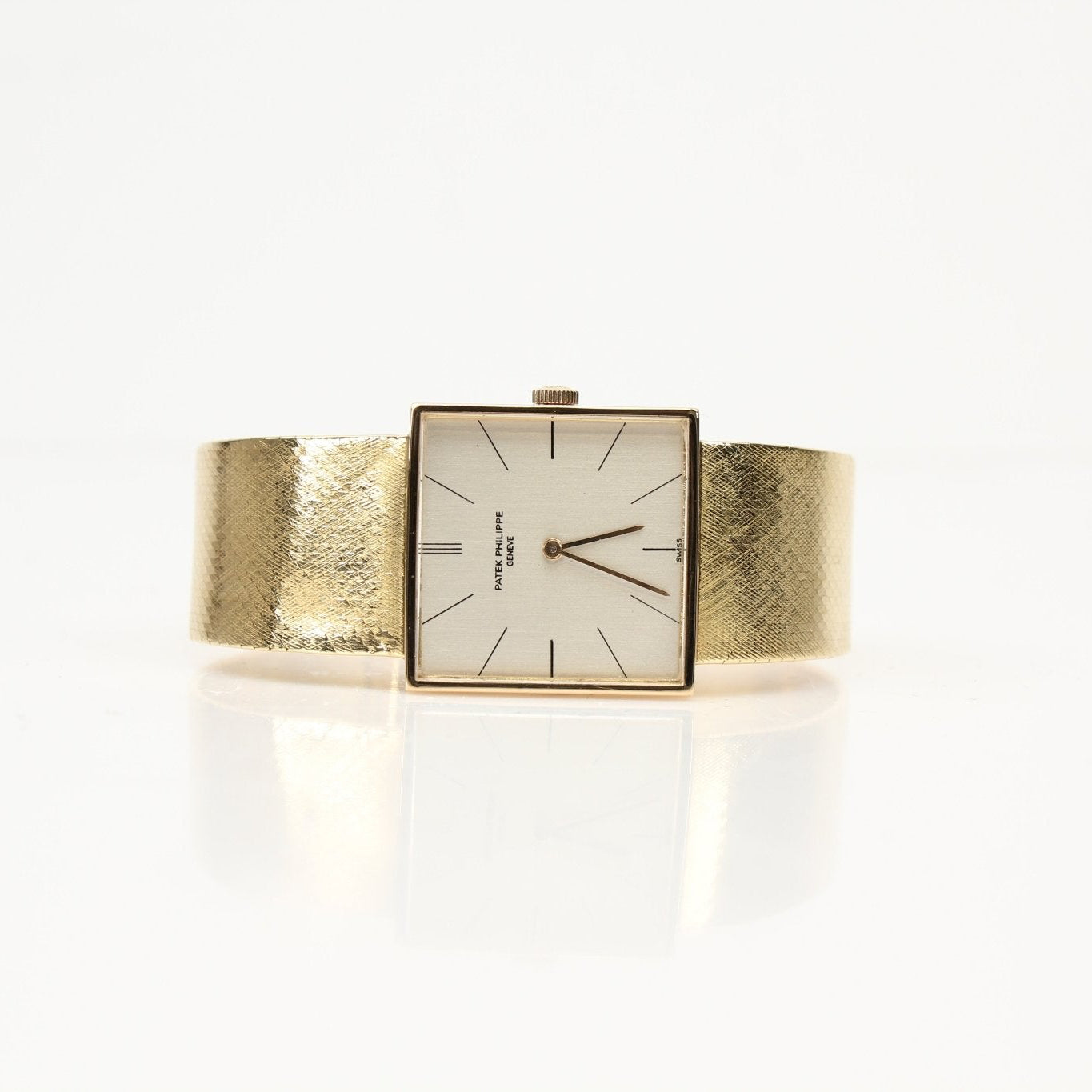 Gold & Beyond Patek Philippe square dress watch with gold case and leather strap displayed on a white background.