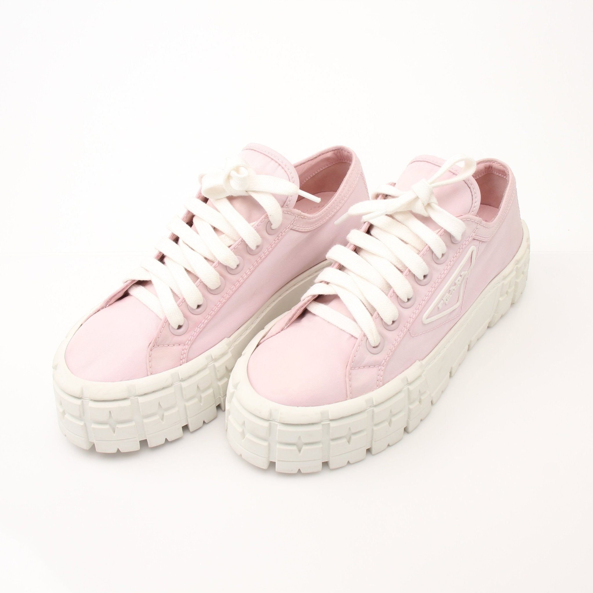 Prada pink nylon platform sneakers with double wheels, featuring a sporty design and chunky sole, from Gold & Beyond.