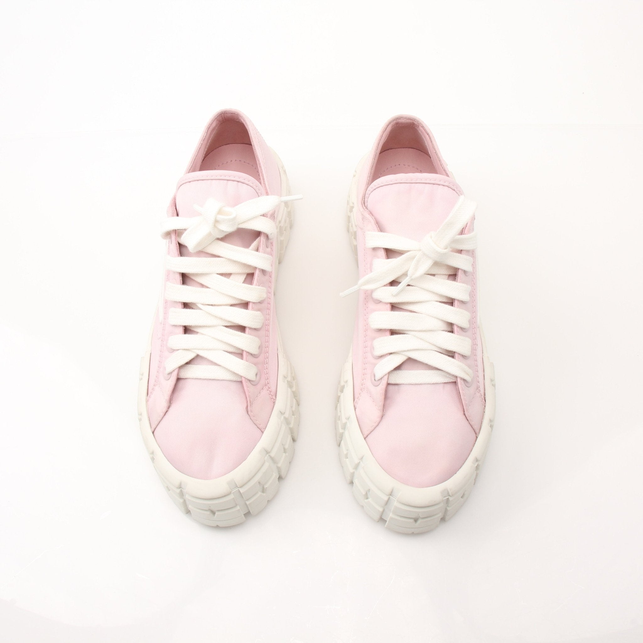 Prada pink nylon double wheel platform sneakers with white soles and laces, showcasing a trendy athletic shoe design.