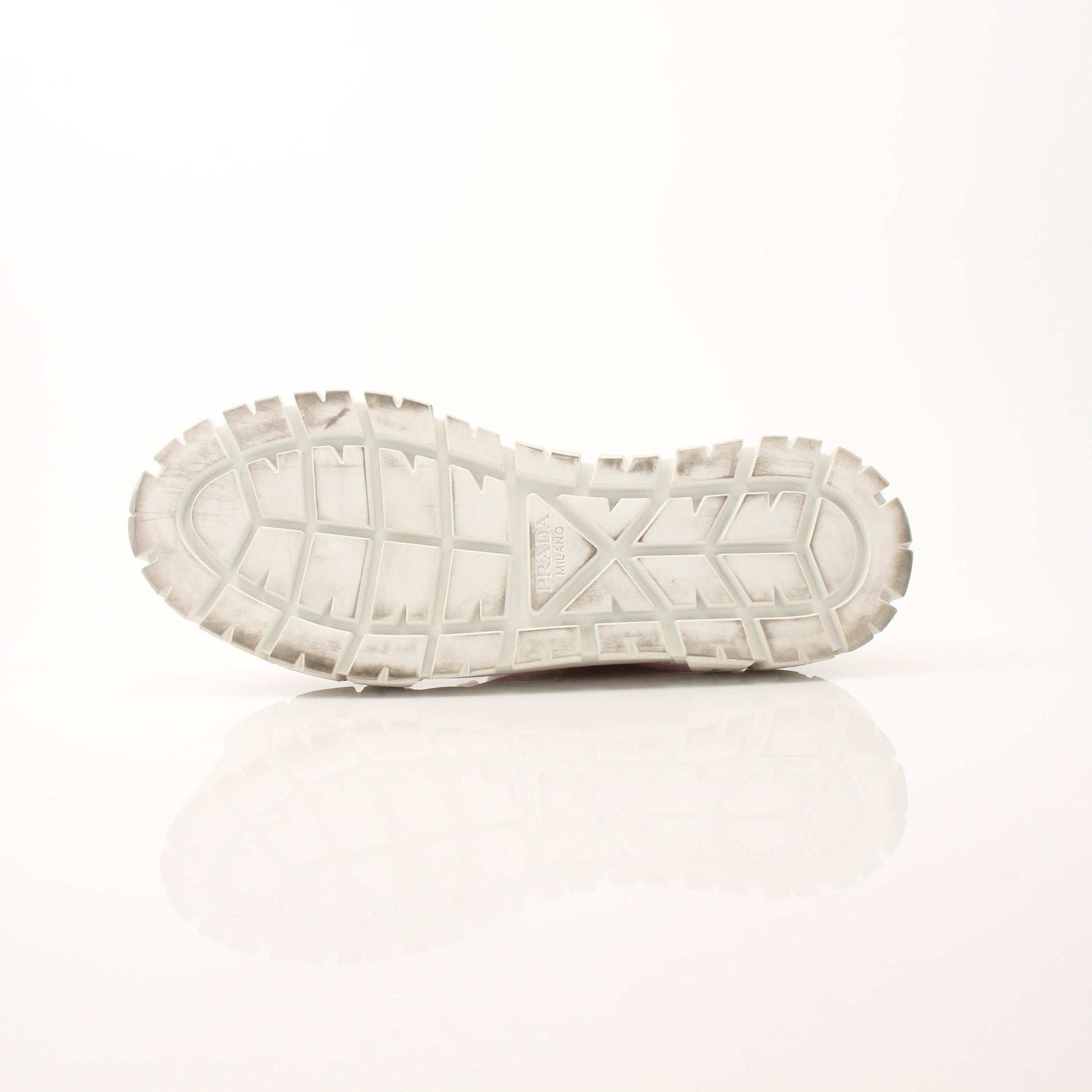 Pink Prada nylon double wheel platform sneakers with chunky soles and sporty design, worn on a casual street setting.
