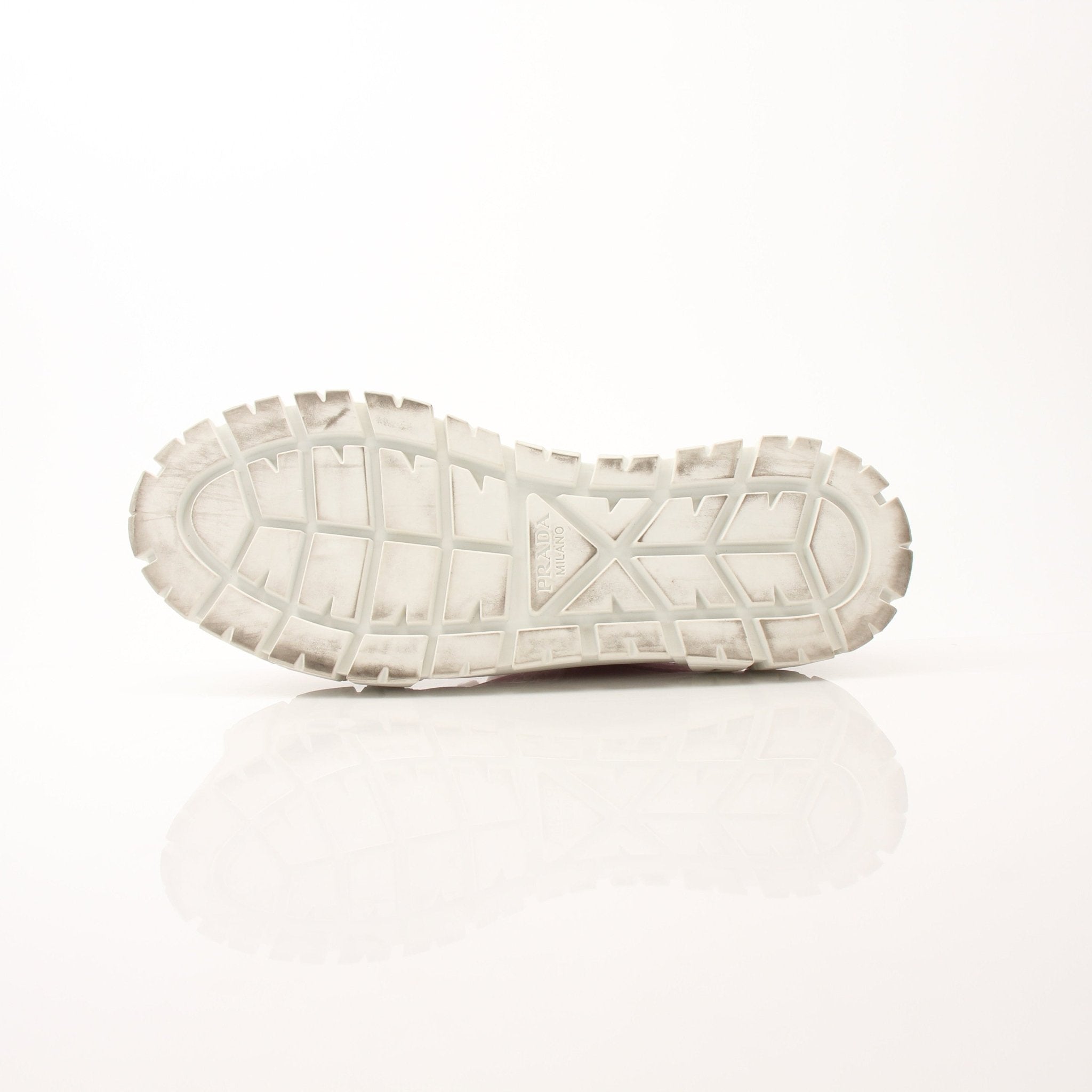 Pink Prada nylon double wheel platform sneakers with chunky soles and sporty design, worn on a casual street setting.