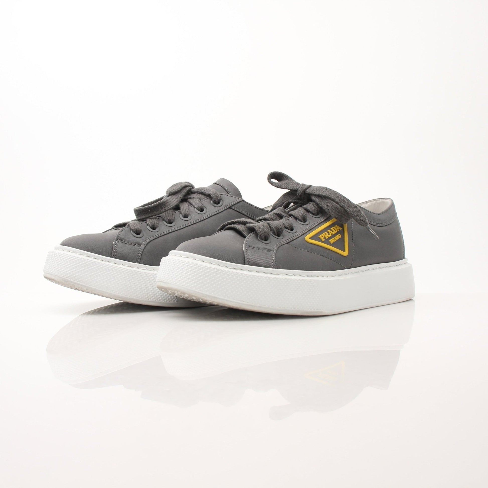 Prada gray Re-Nylon gabardine platform sneakers with white soles, designed for stylish comfort and modern appeal.