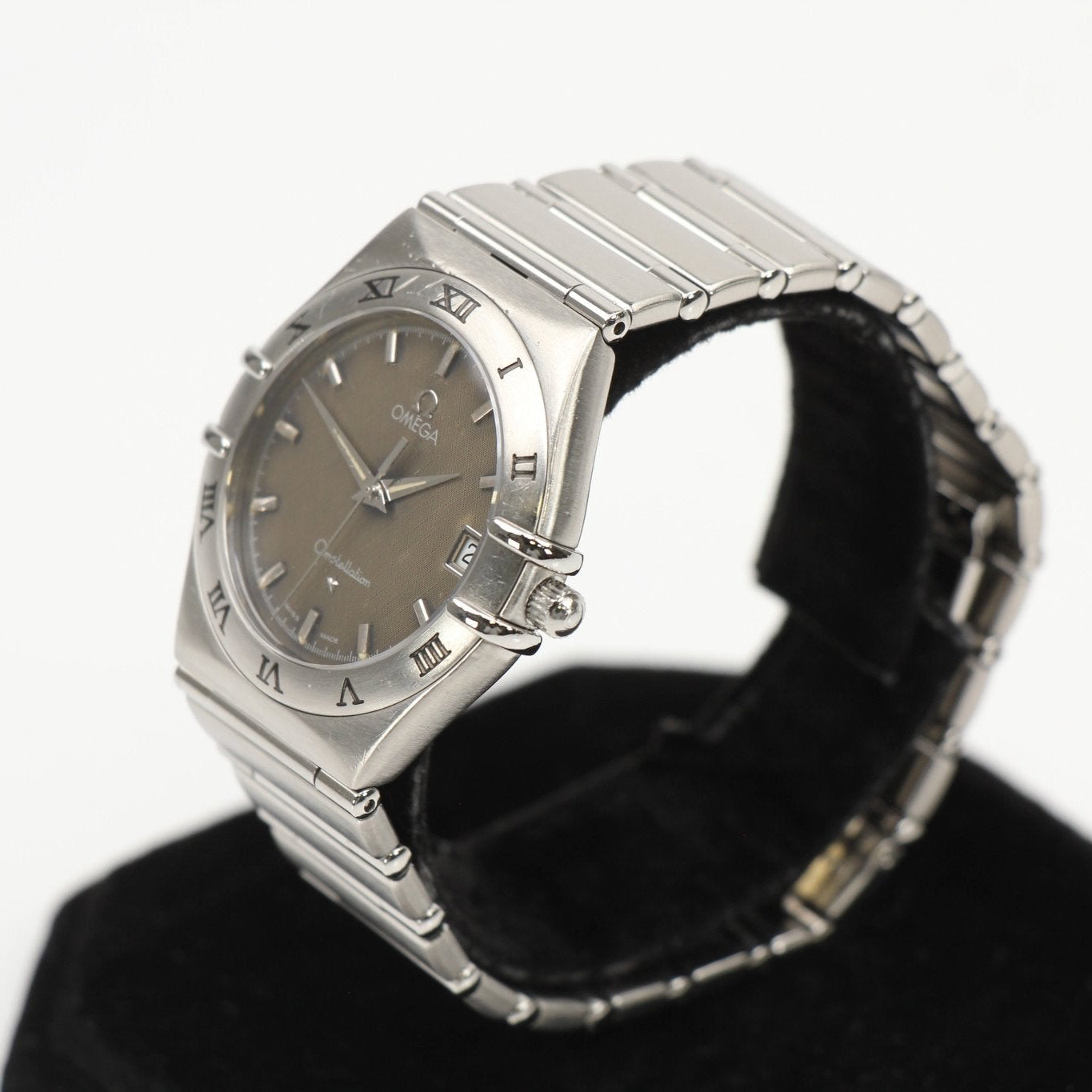 Omega Constellation Chronometer watch with gold-tone case and bracelet, featuring a white dial and date display.