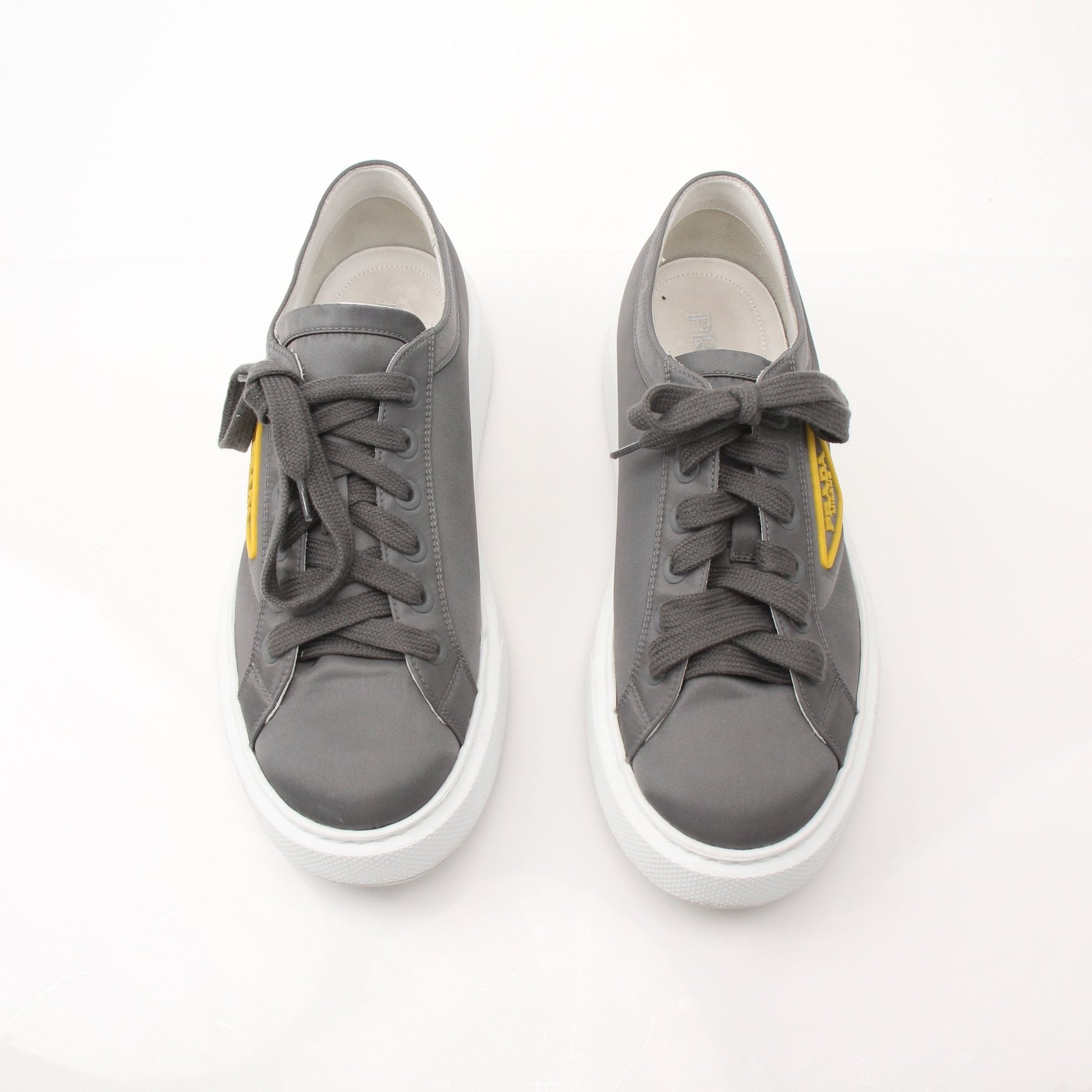 Prada gray Re-Nylon gabardine platform sneakers with white soles and laced front, stylish and modern shoes from Gold & Beyond