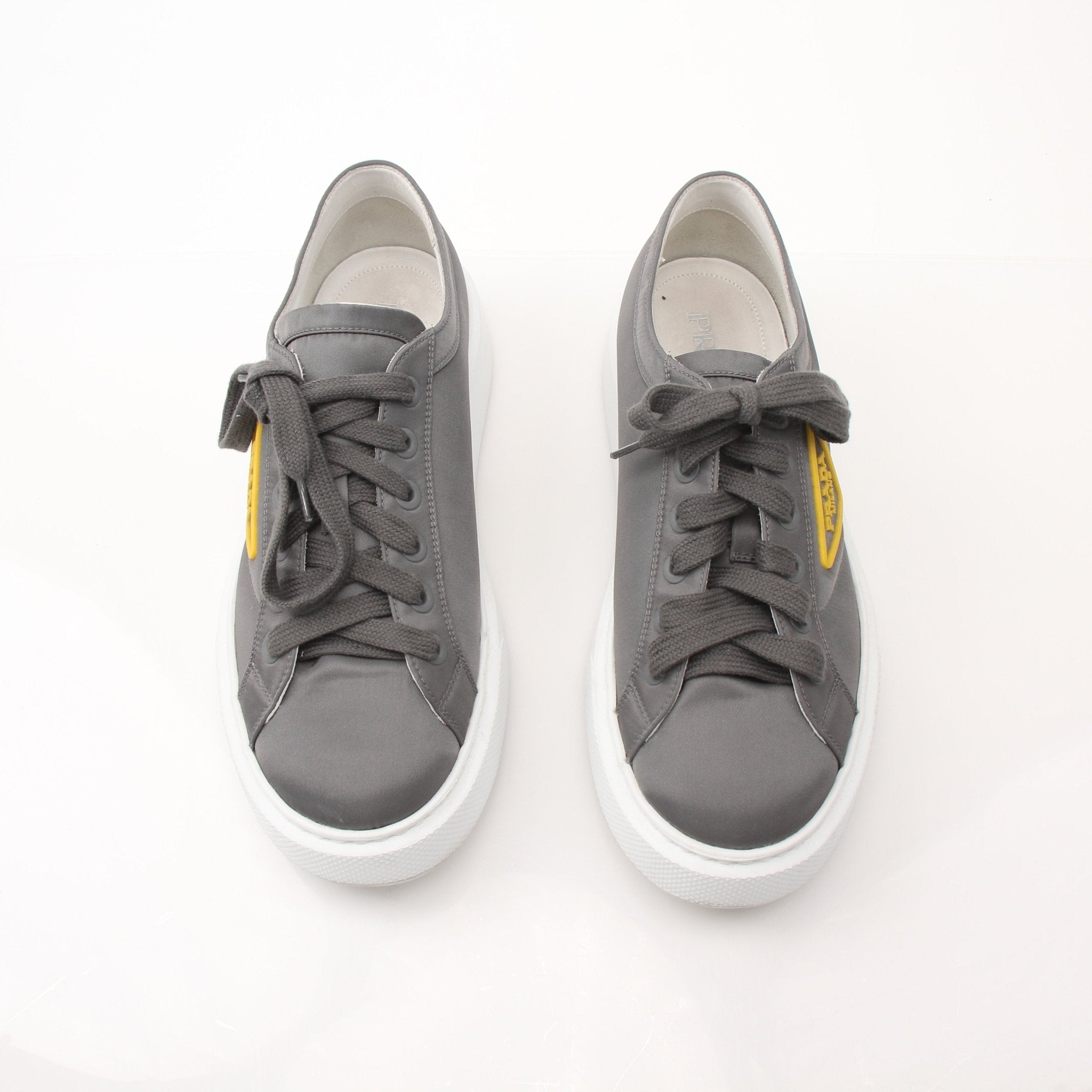 Prada gray Re-Nylon gabardine platform sneakers with white soles and laced front, stylish and modern shoes from Gold & Beyond